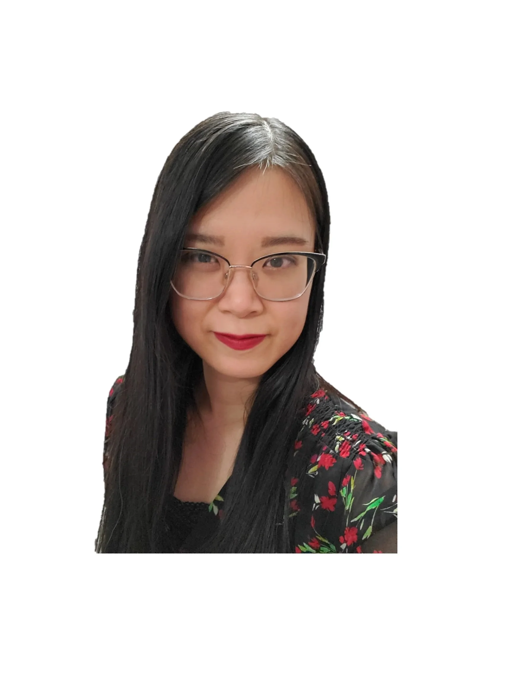 A woman with long black hair and glasses, wearing a black floral top, smiling at the camera against a white background.