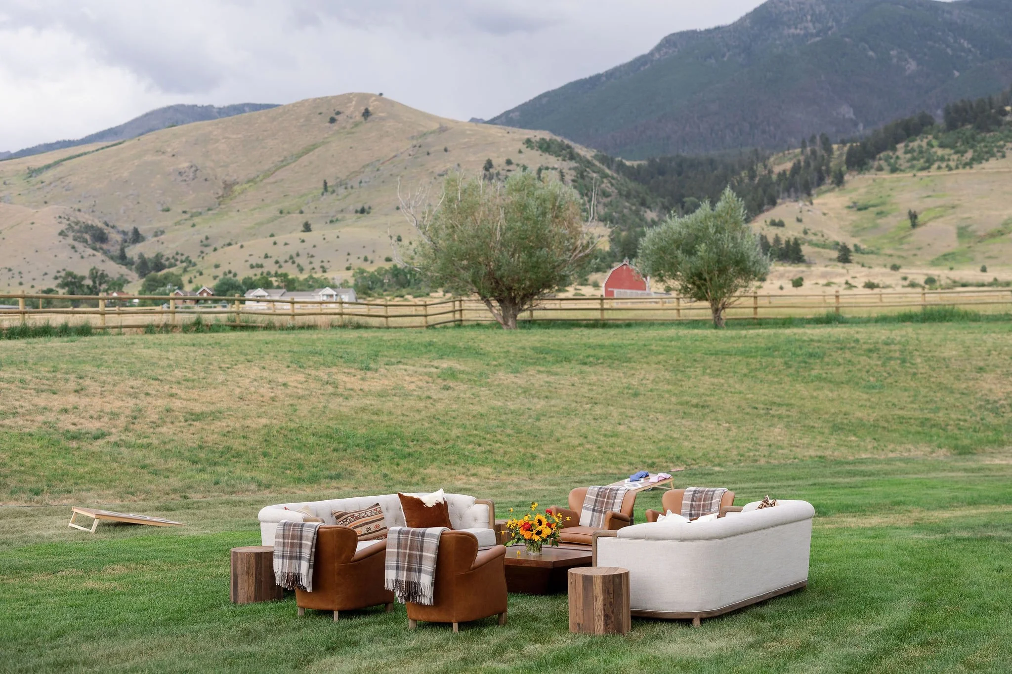 Outdoor wedding lounge seating area styled in an open Montana valley with sweeping mountain and ranch views, by Wild Blume