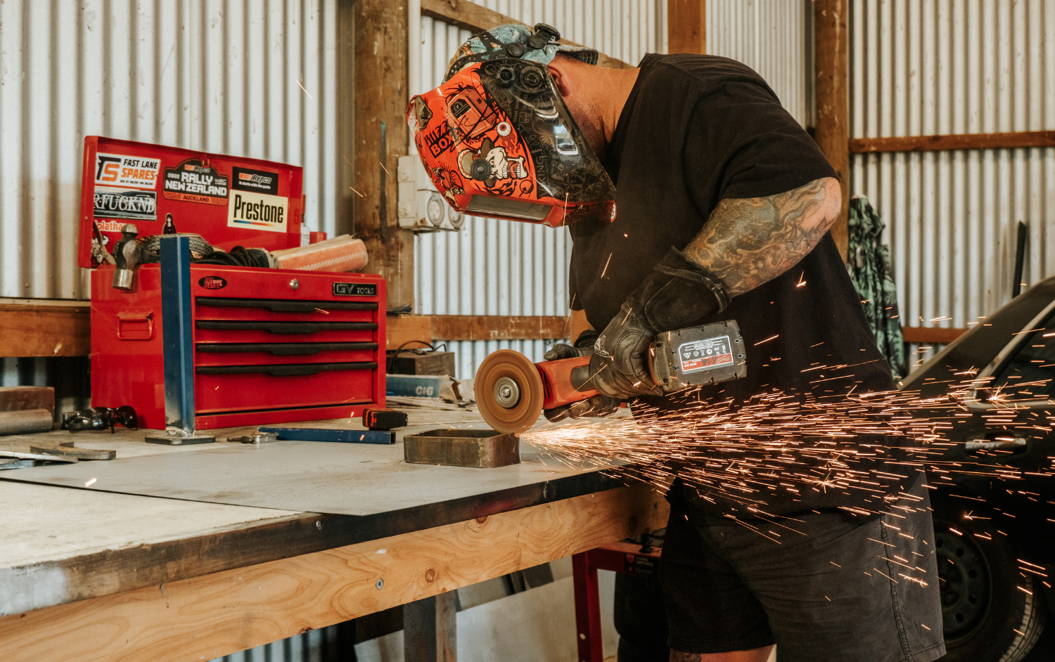 Angle grinder cutting steel in Hawke’s Bay workshop