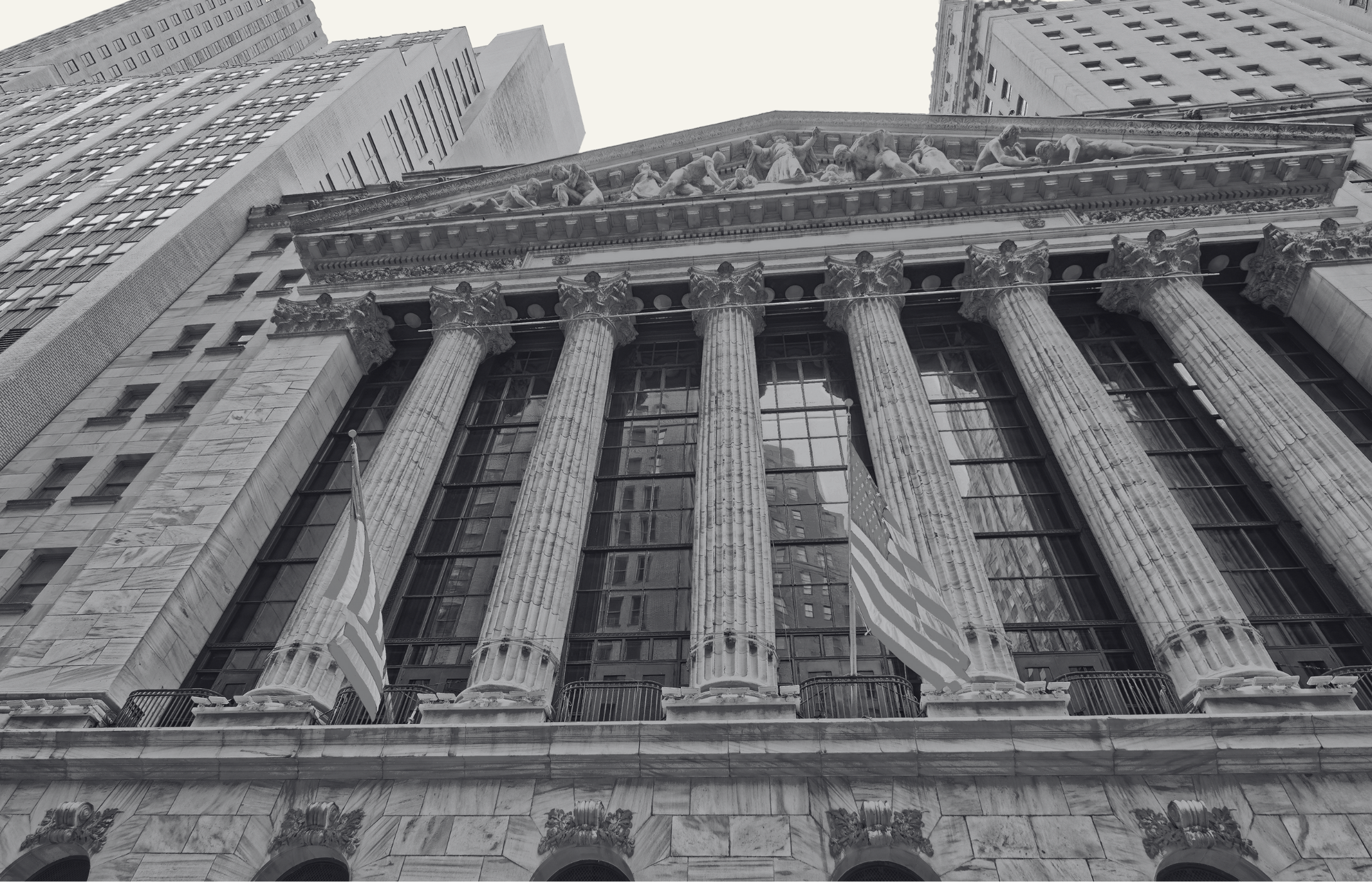 Historic financial district building with grand neoclassical columns and American flags, symbolizing global finance, capital markets, and The Lockett Circle’s investment philosophy.