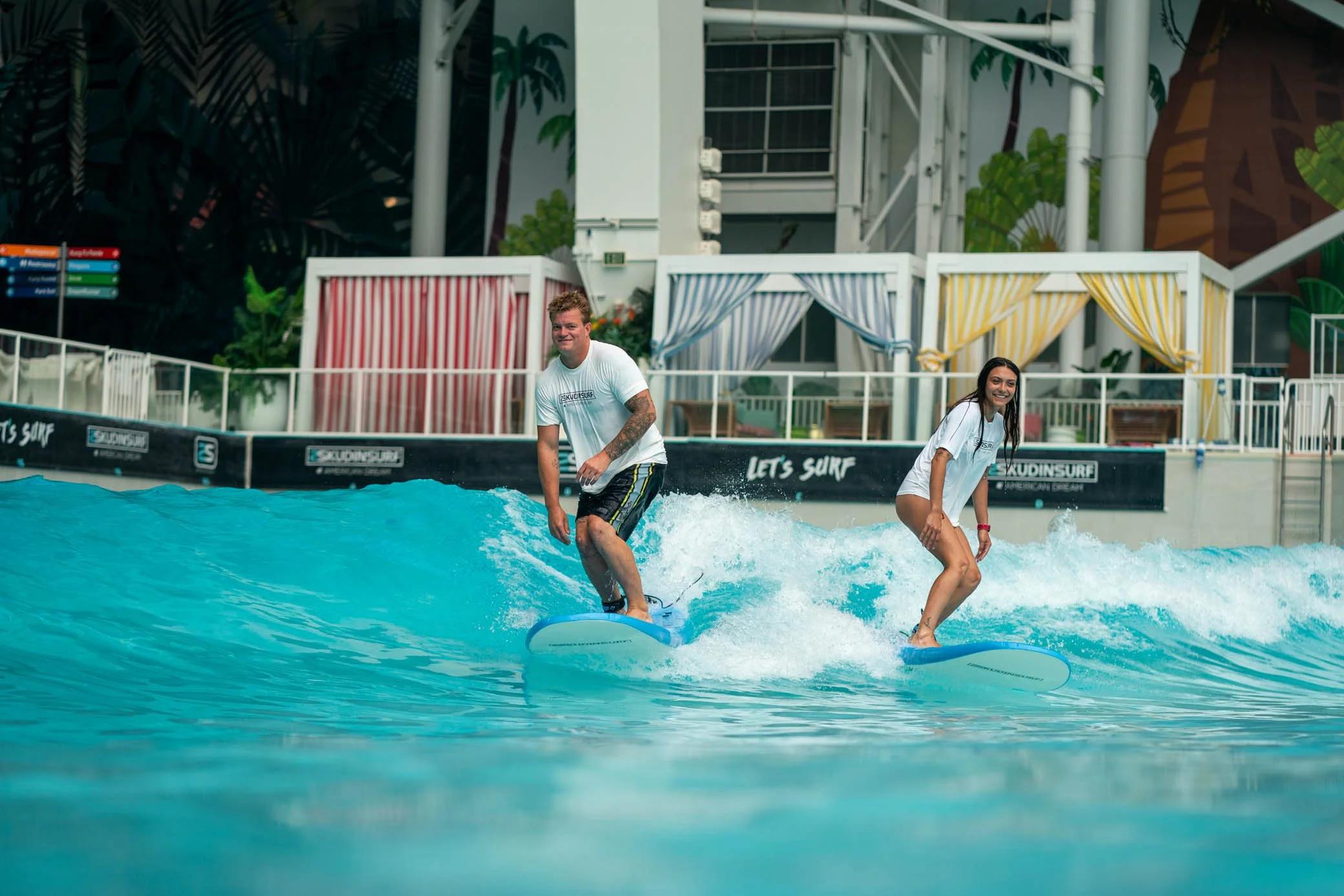 Intermediate surfer carving on indoor wave at American Dream