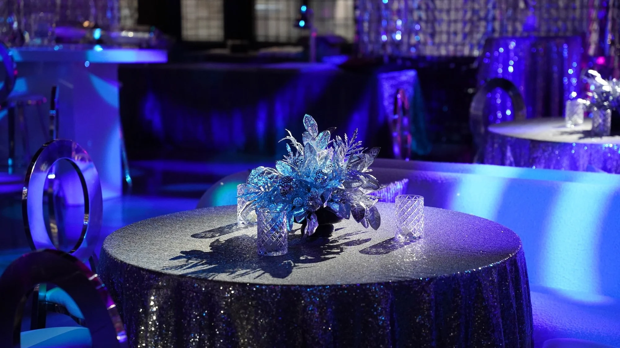 Elegant banquet table with a sparkly silver tablecloth HSP event production in Boston MA