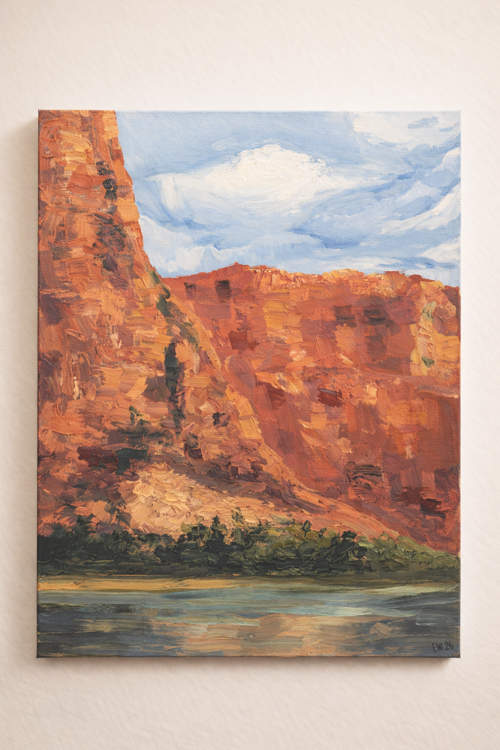 Oil painting of a canyon with red rock cliffs, green vegetation at the base, blue sky with white clouds above, and a body of water in the foreground.
