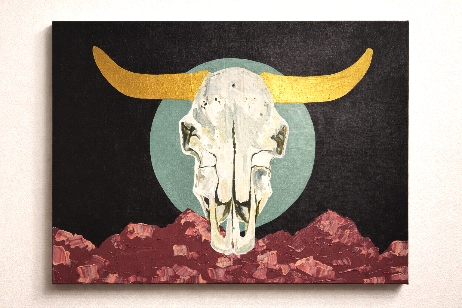 Painting of a cow skull with yellow horns, set against a black background with a green circle behind it, and pink mountains at the bottom.