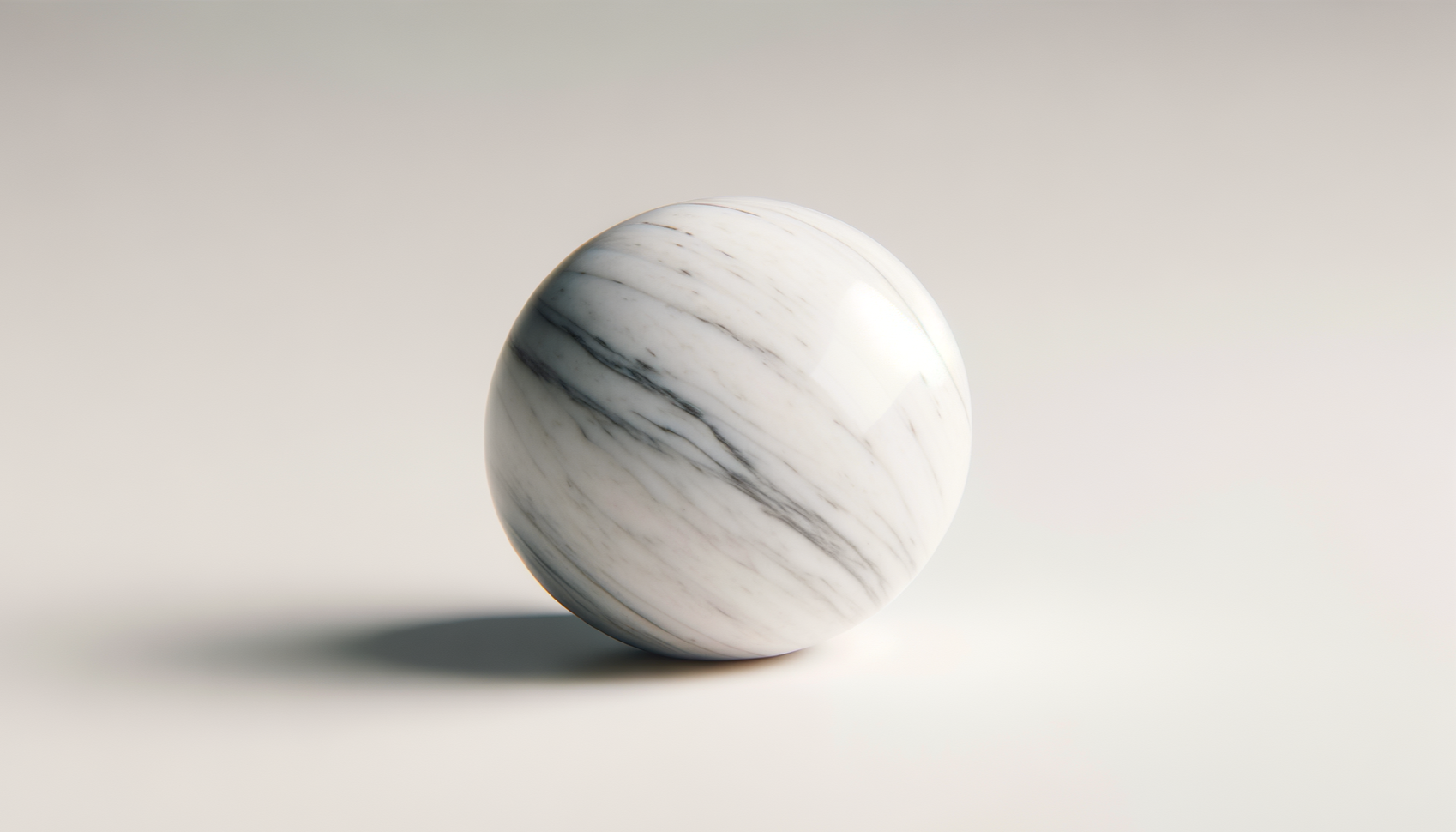 A polished white marble sphere with gray veining on a plain, light background, casting a shadow.