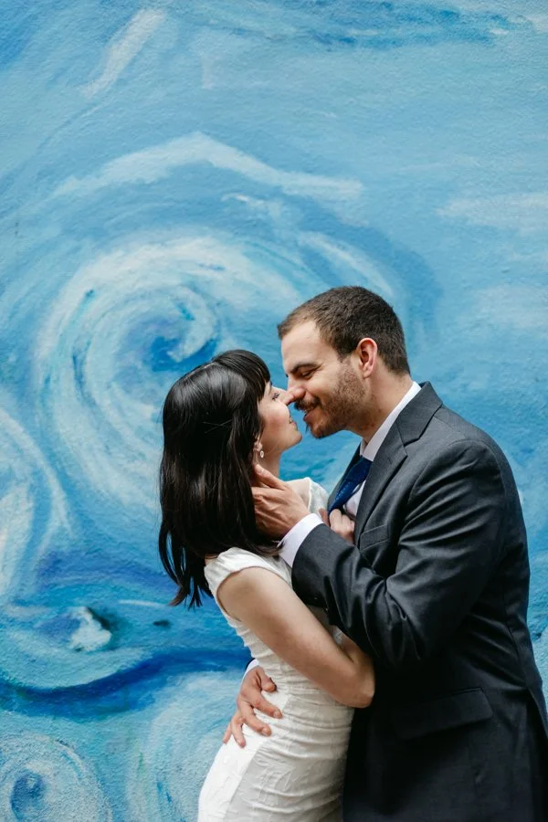 downtown engagement session in portland, oregon. couple kissing in front of art mural