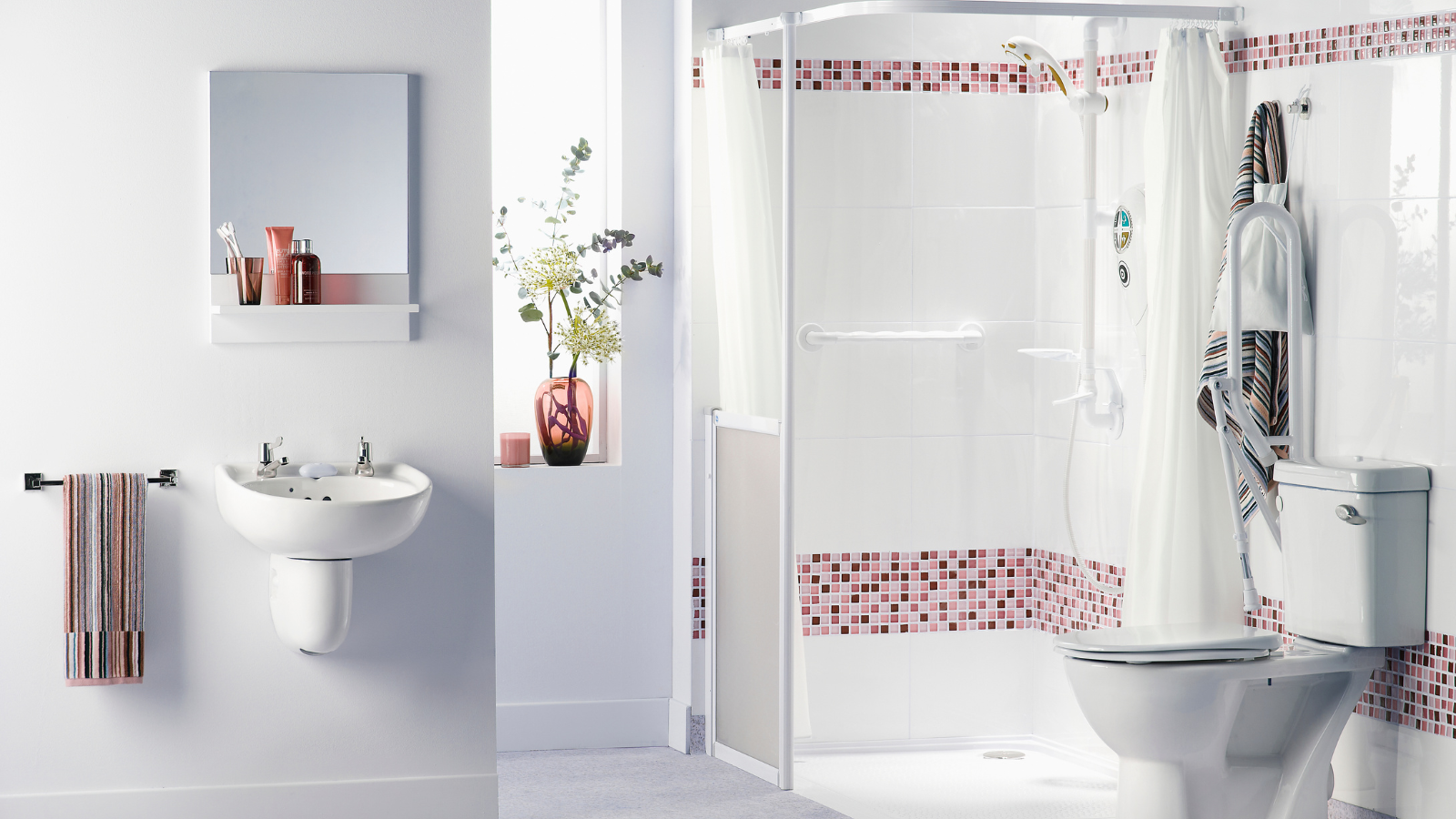 Bright bathroom with sink, mirror, and shower area with red mosaic tile accents.