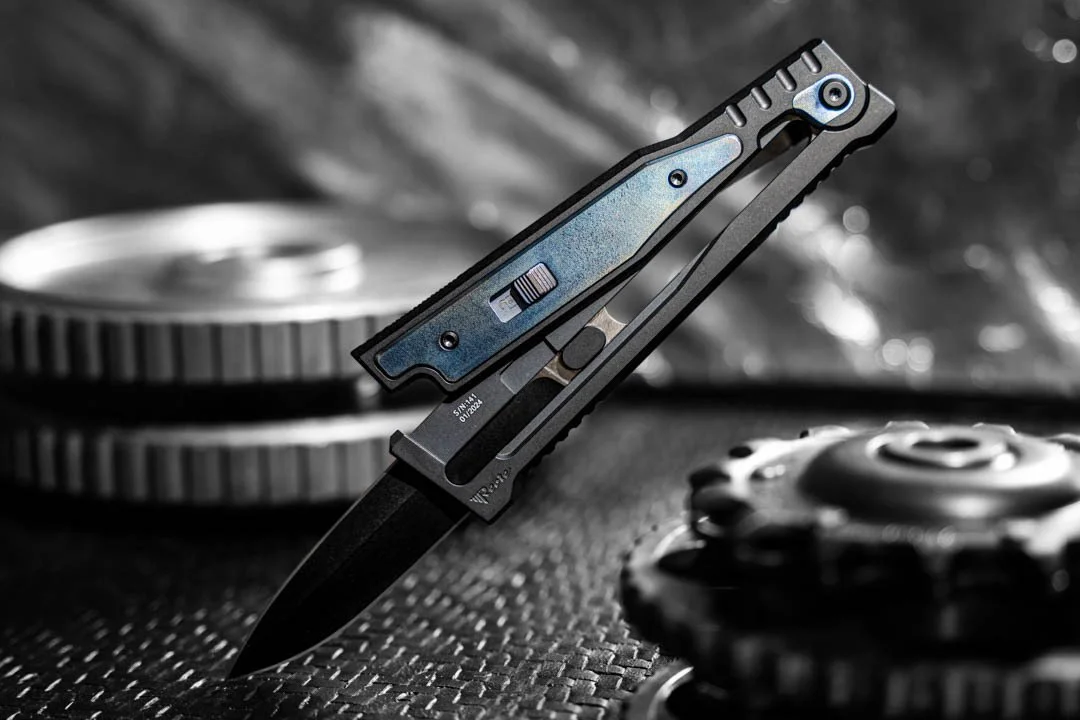 A folding knife with a partially open blade, surrounded by metallic gears and coins.