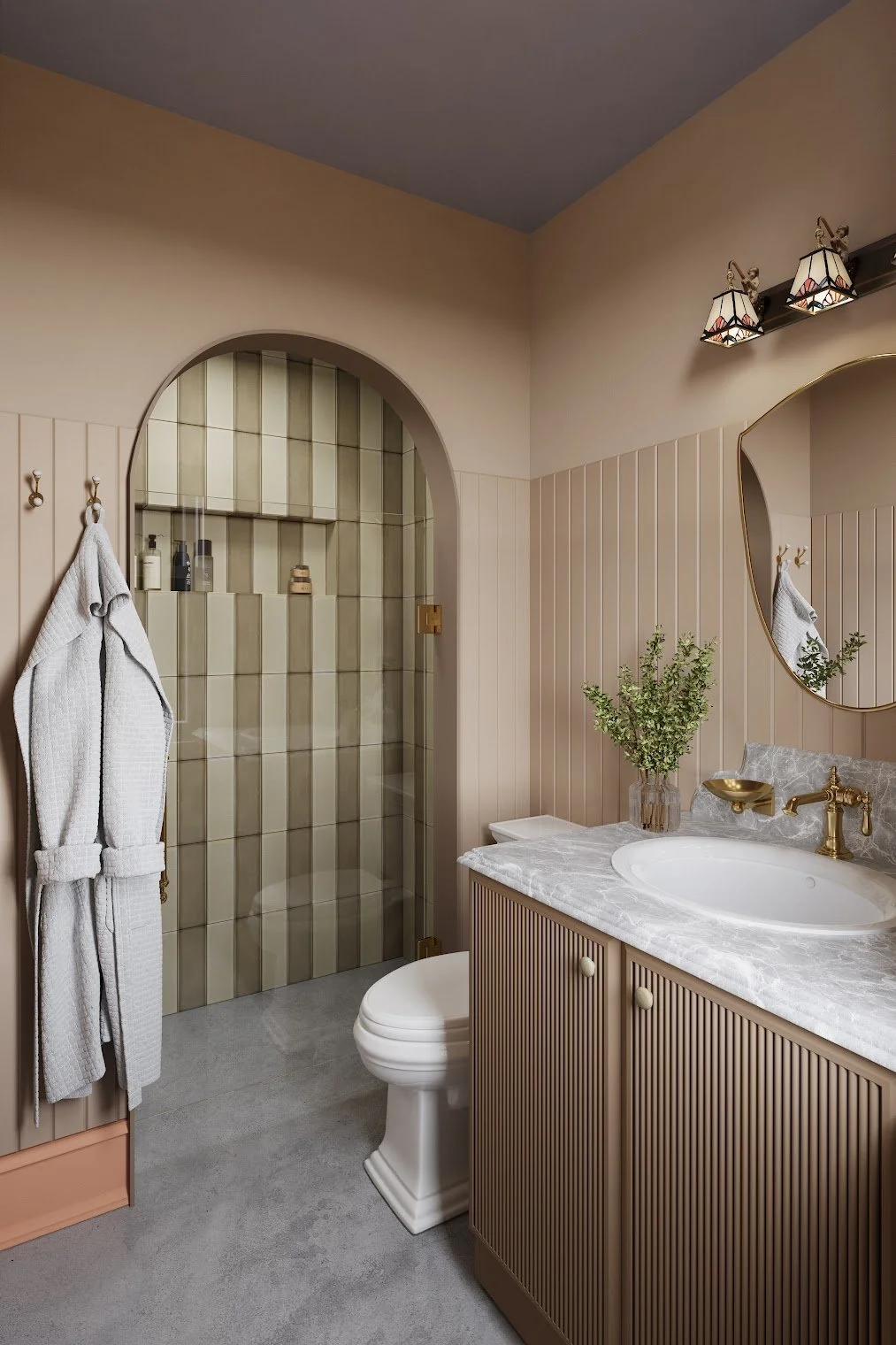 A decorated bathroom featuring a beige paneled wall, a wooden vanity with a marble top, a white porcelain toilet, a walk-in shower with beige tiles behind a glass door, a large mirror, and a potted plant on the vanity. There are two hanging light fix