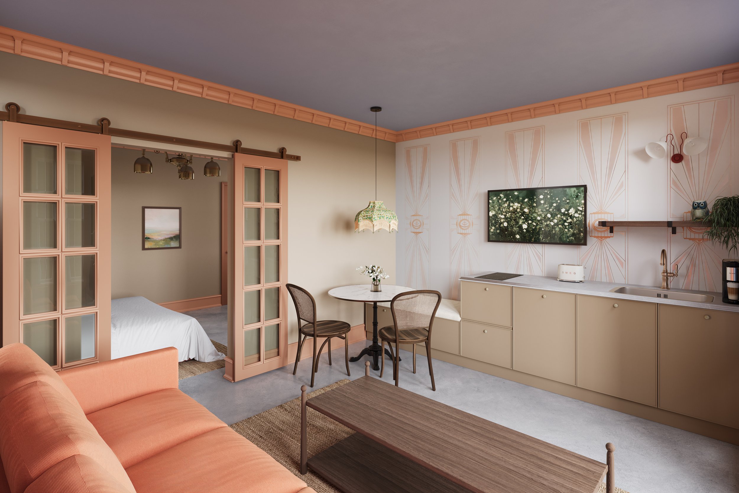 Interior of a cozy living space with a peach-colored sofa, a small round dining table with chairs, a wall-mounted TV, a kitchen area with beige cabinets, a sink, and wall decor including a painting and owl figurines.