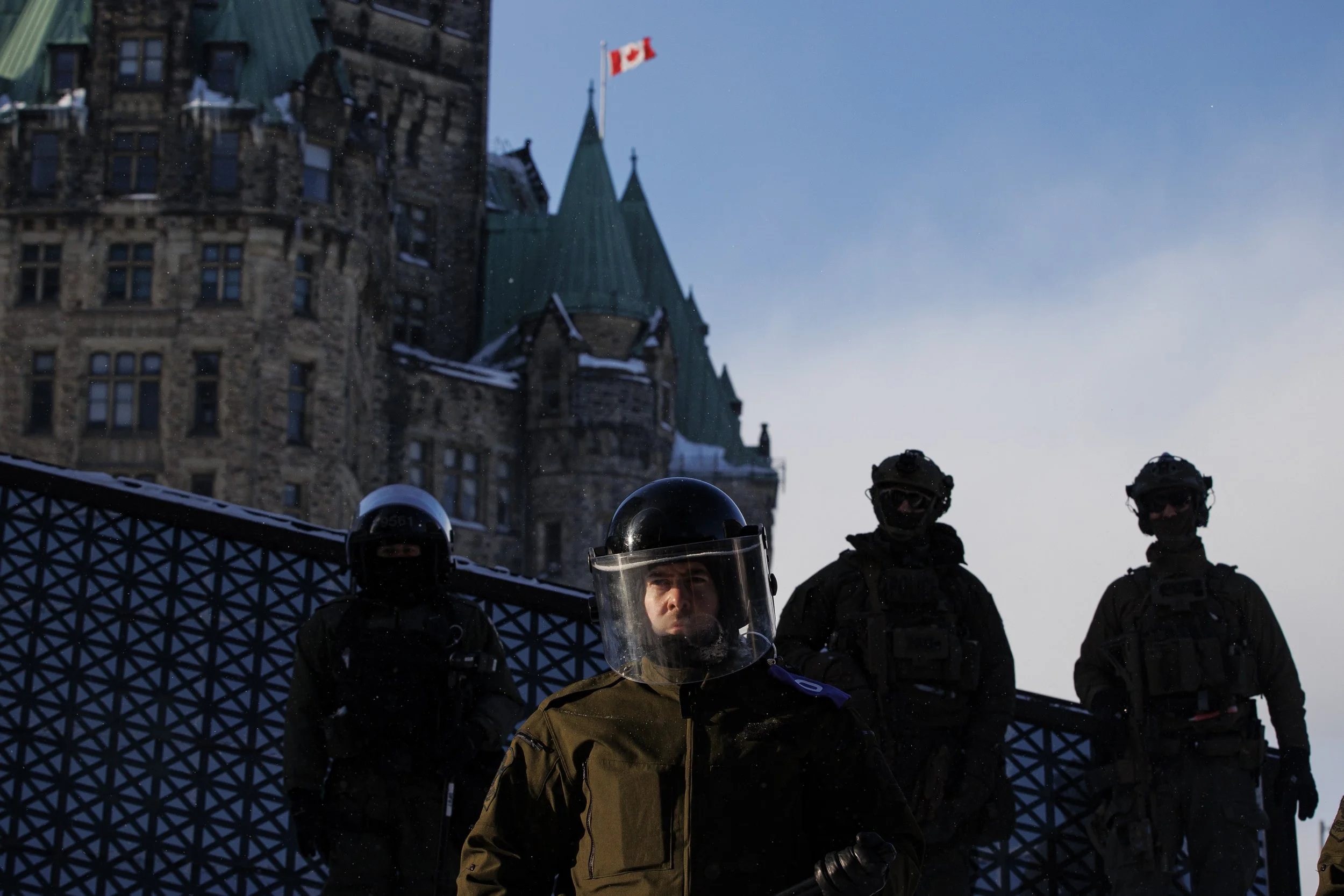 Police enforce an injunction against protesters, some who have been camped in their trucks near Parliament Hill for weeks, on Feb. 19, 2022.
