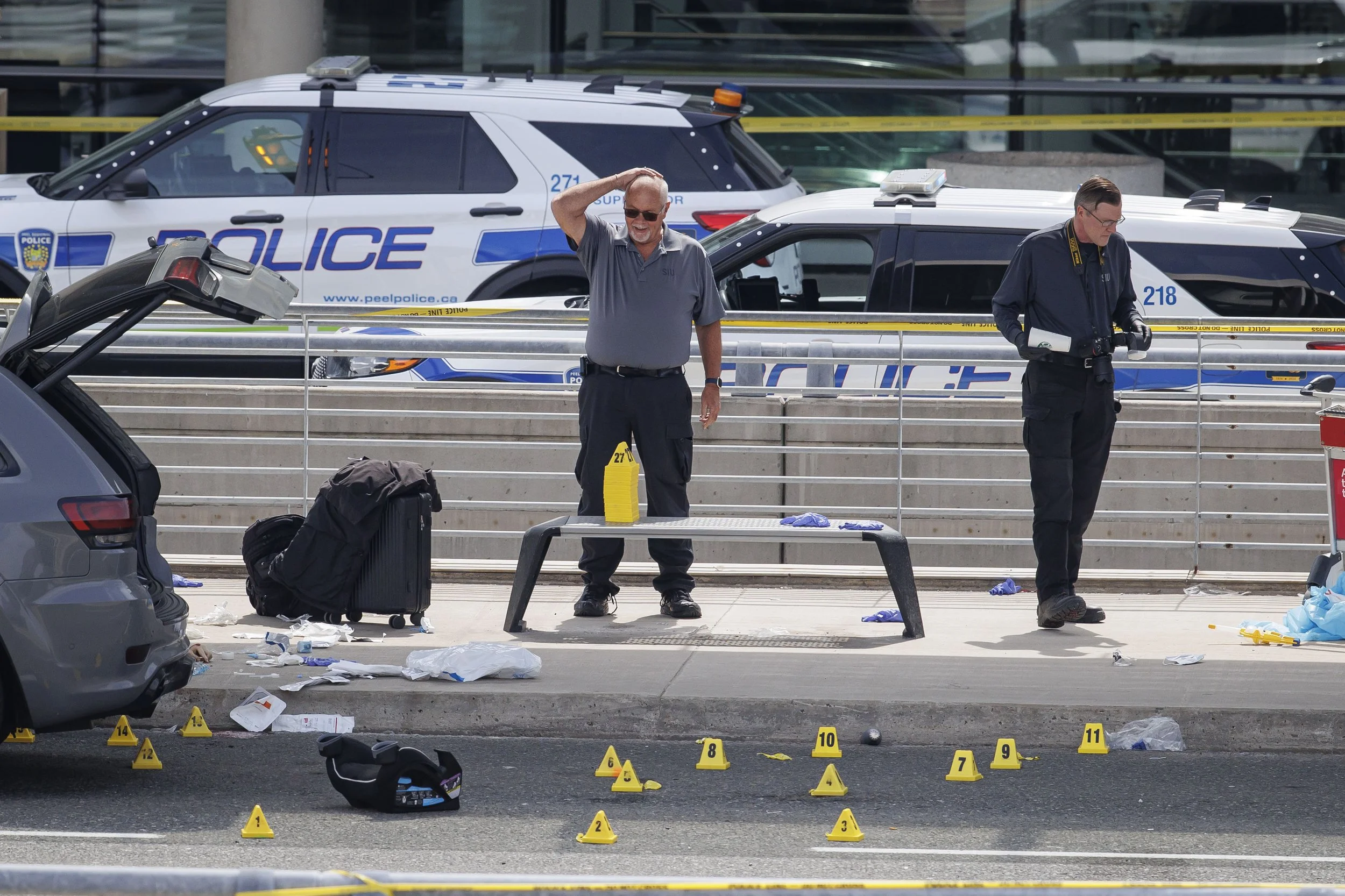 Forensics survey the site of a police-involved shooting outside Terminal 1 at Toronto’s Pearson Airport, April 24, 2025.