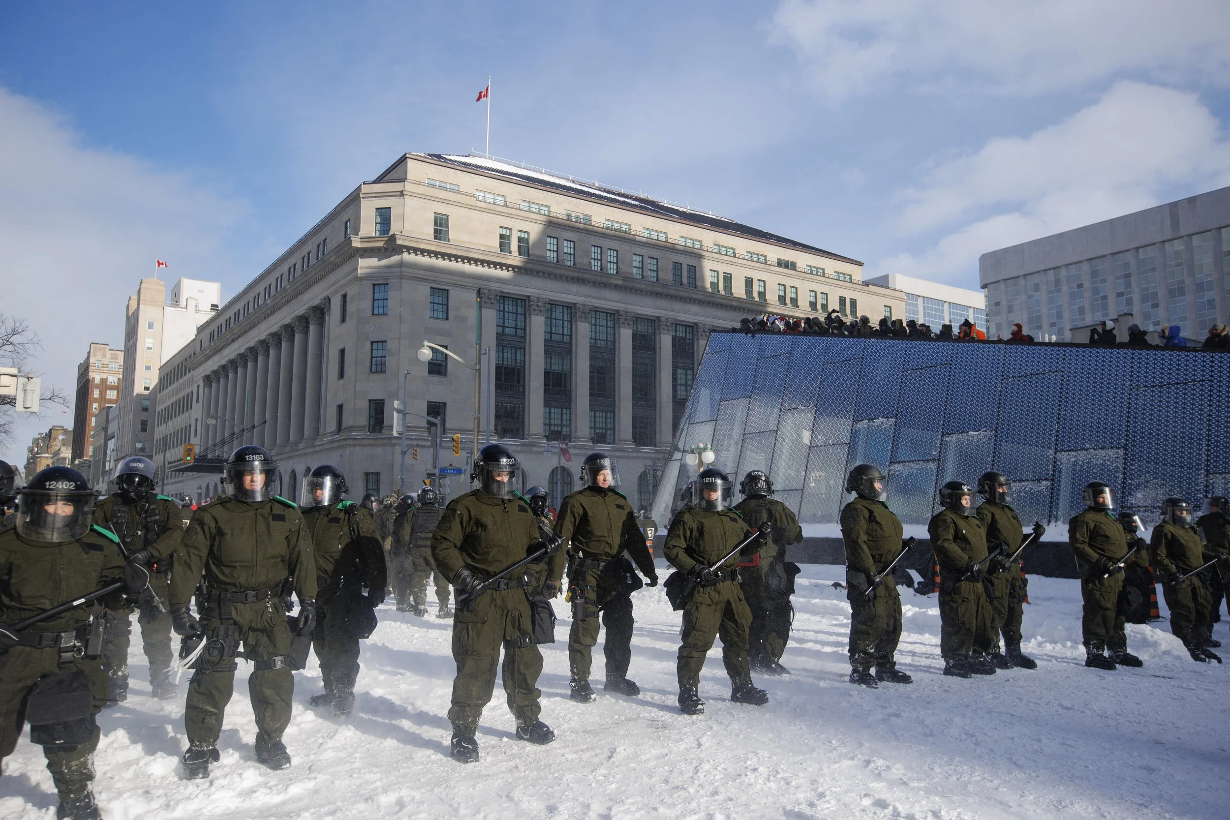 Police officers from Quebec join a force of thousands brought in to clear the remnants of the freedom convoy encampment, near Parliament Hill, on Feb. 19, 2022.