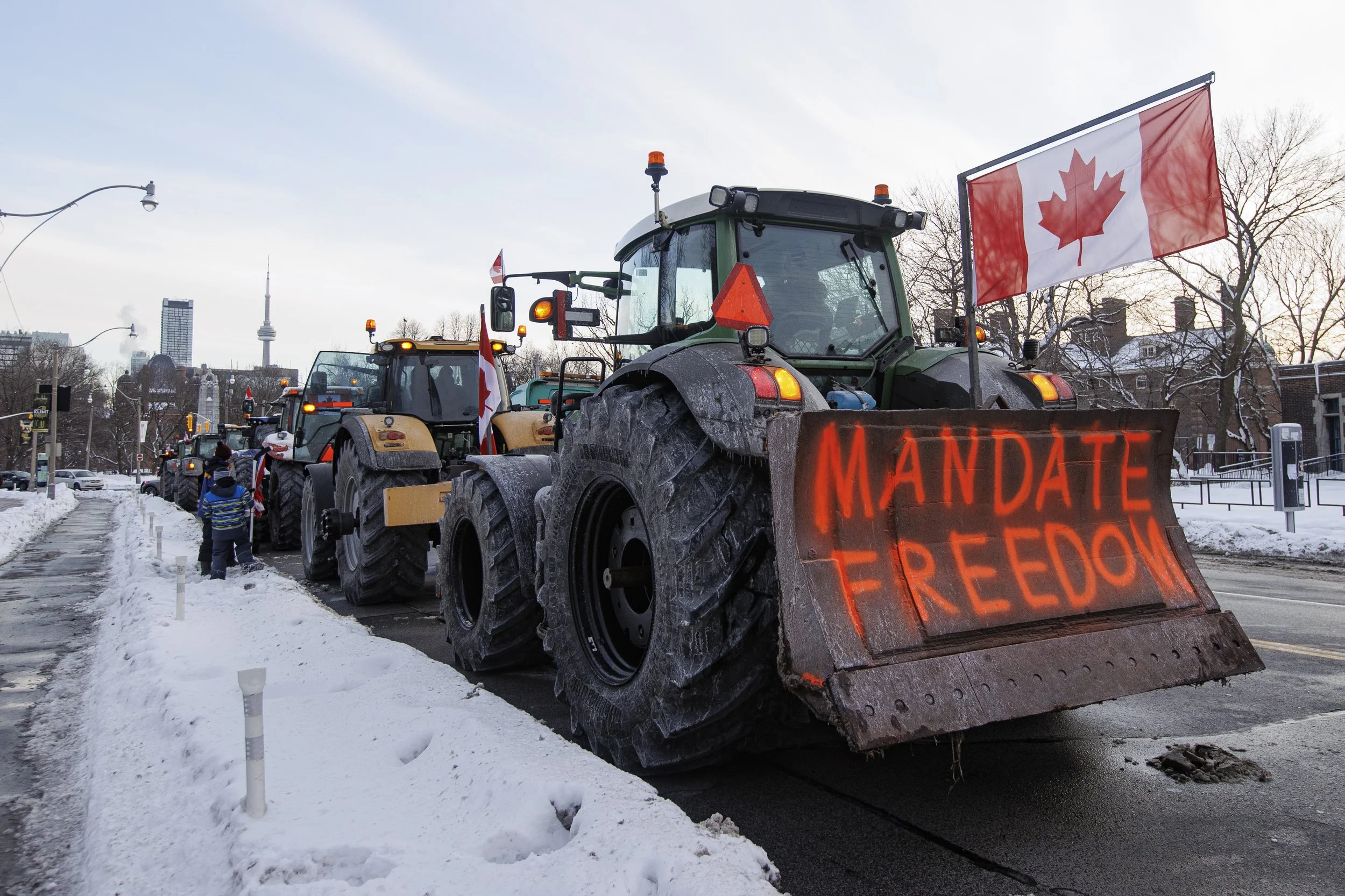 Farmers in solidarity with the convoy truckers brought their tractors to the provincial legislature, in Toronto, on Feb. 4, 2022.