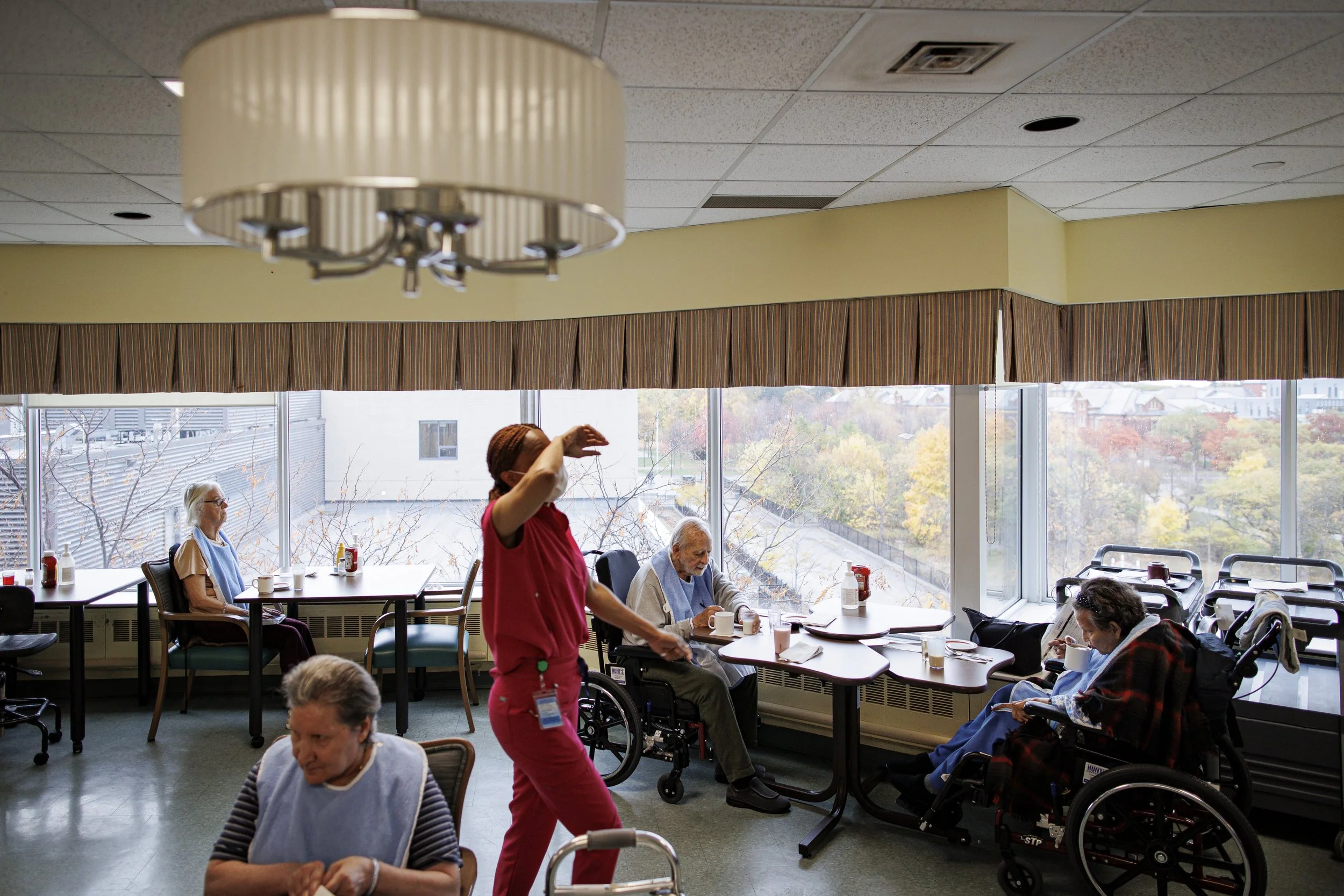 Residents and staff at the city-owned Lakeshore Lodge care home prepare for lunch on Oct. 26, 2022.
