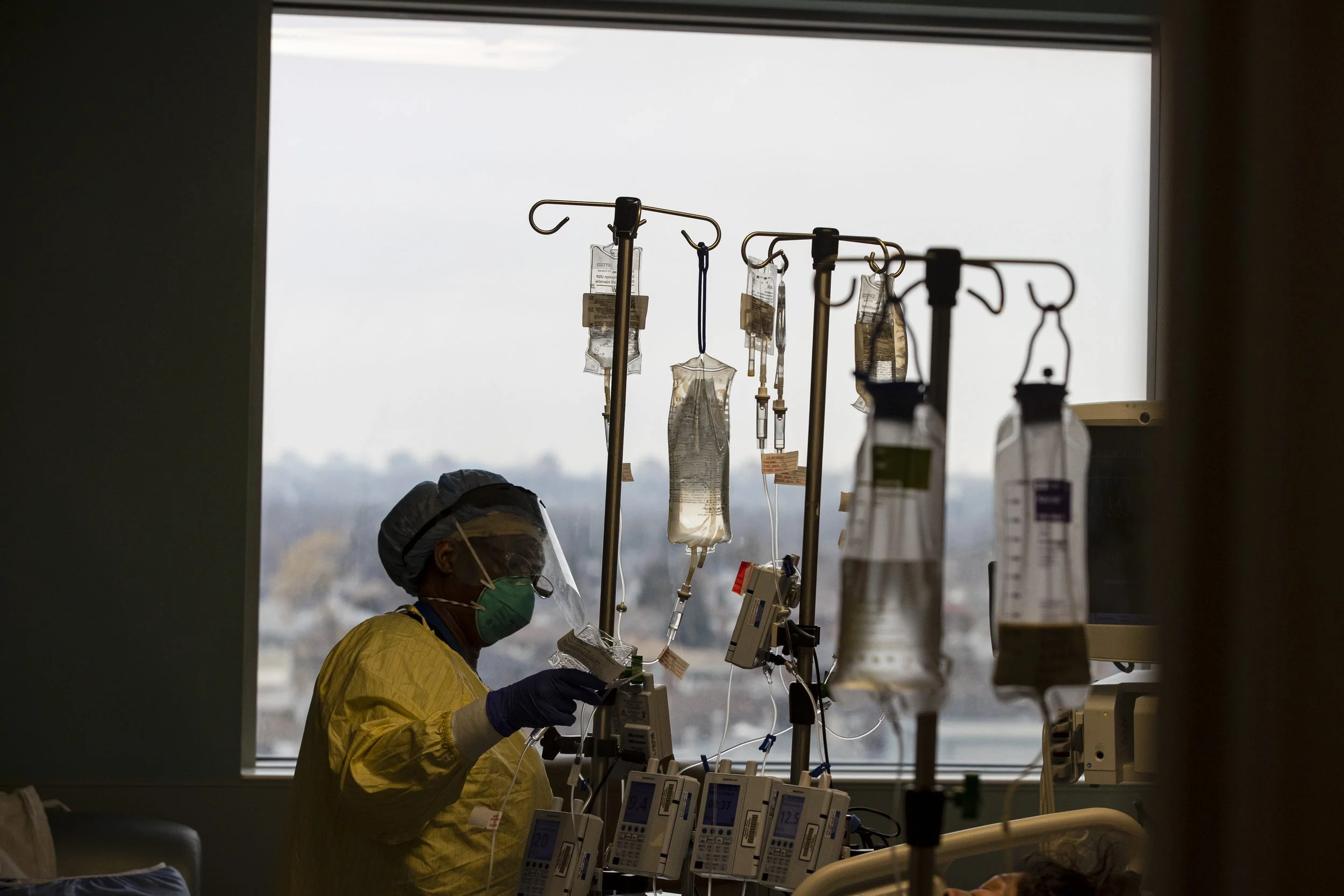 A nurse attends to a COVID-19 positive patient in the Humber River Hospital ICU on Jan. 13, 2022.