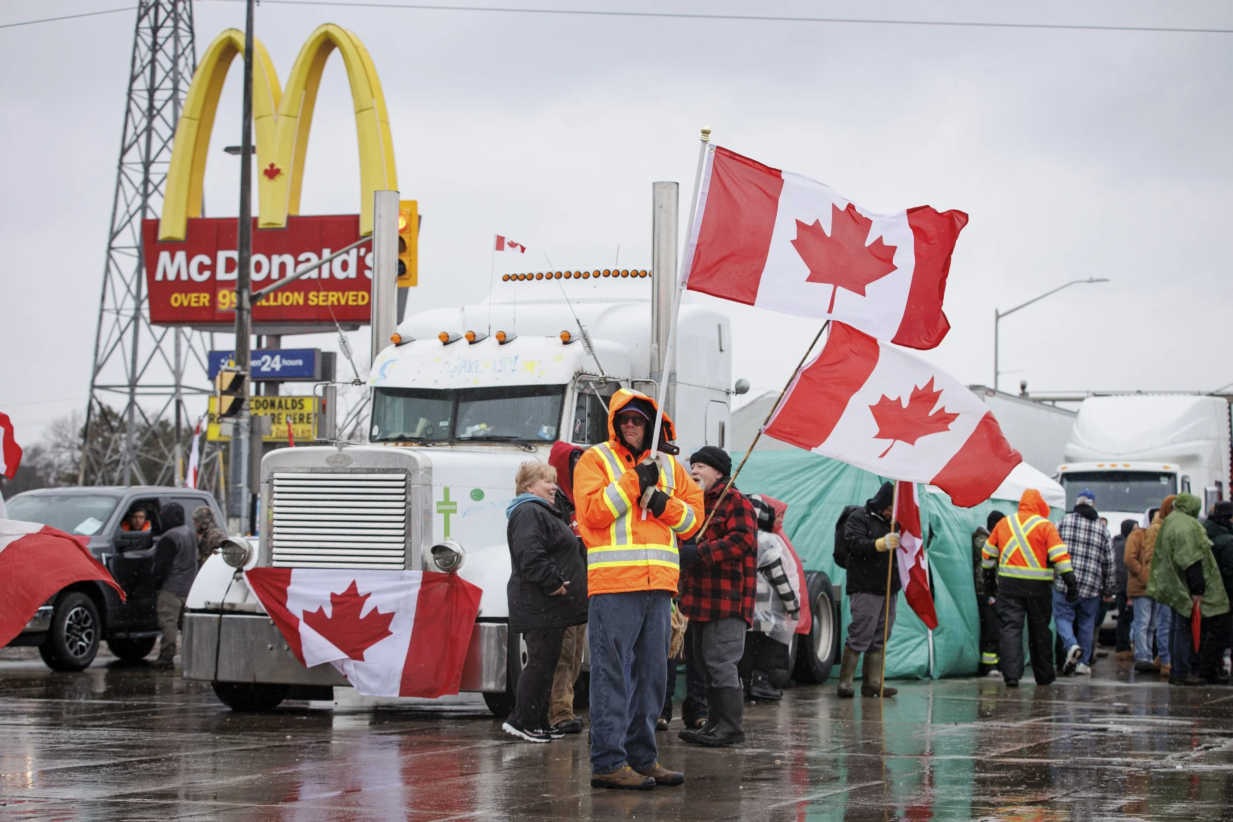 The Ambassador Bridge blockade stopped cross-border travel for days. Here demonstrators show their colours on the  Windsor, Ont., side on Feb. 11, 2022.