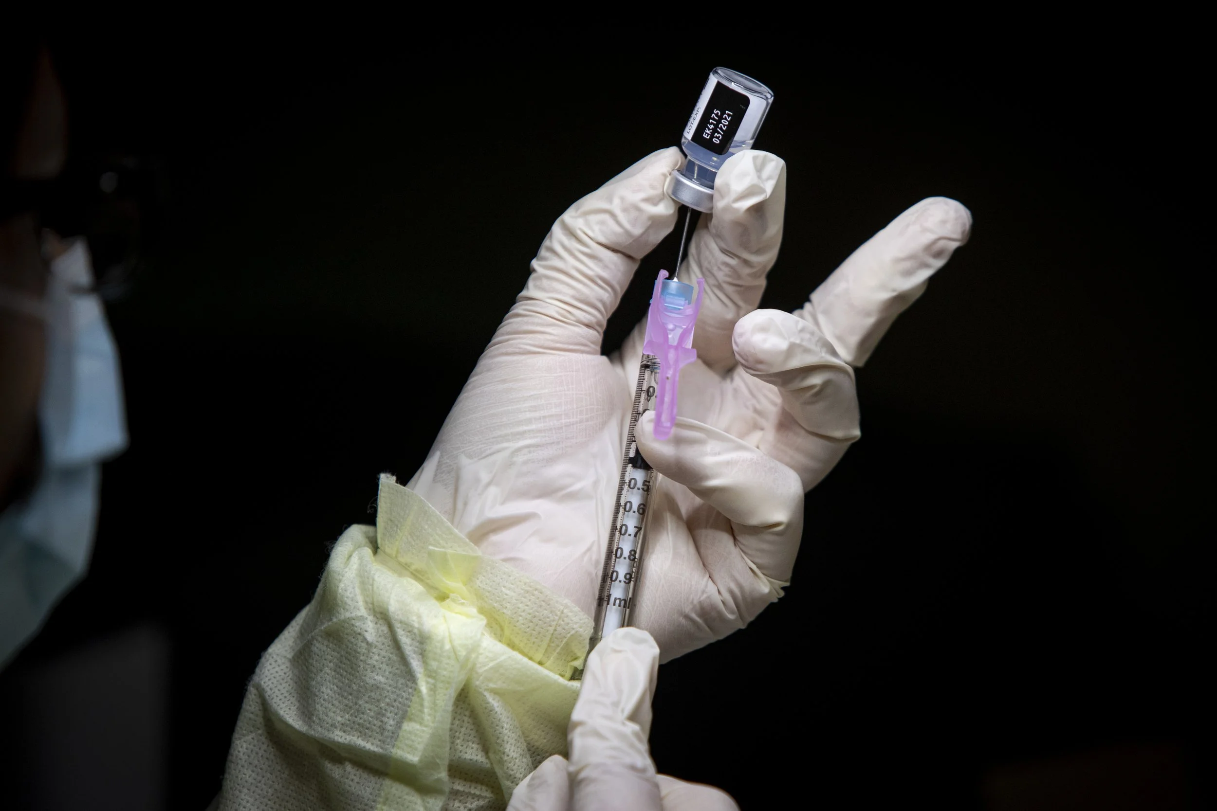 A nurse prepares one of the first doses of Pfizer-BioNTech's COVID-19 vaccine to be administered in Toronto on Dec. 15, 2020.