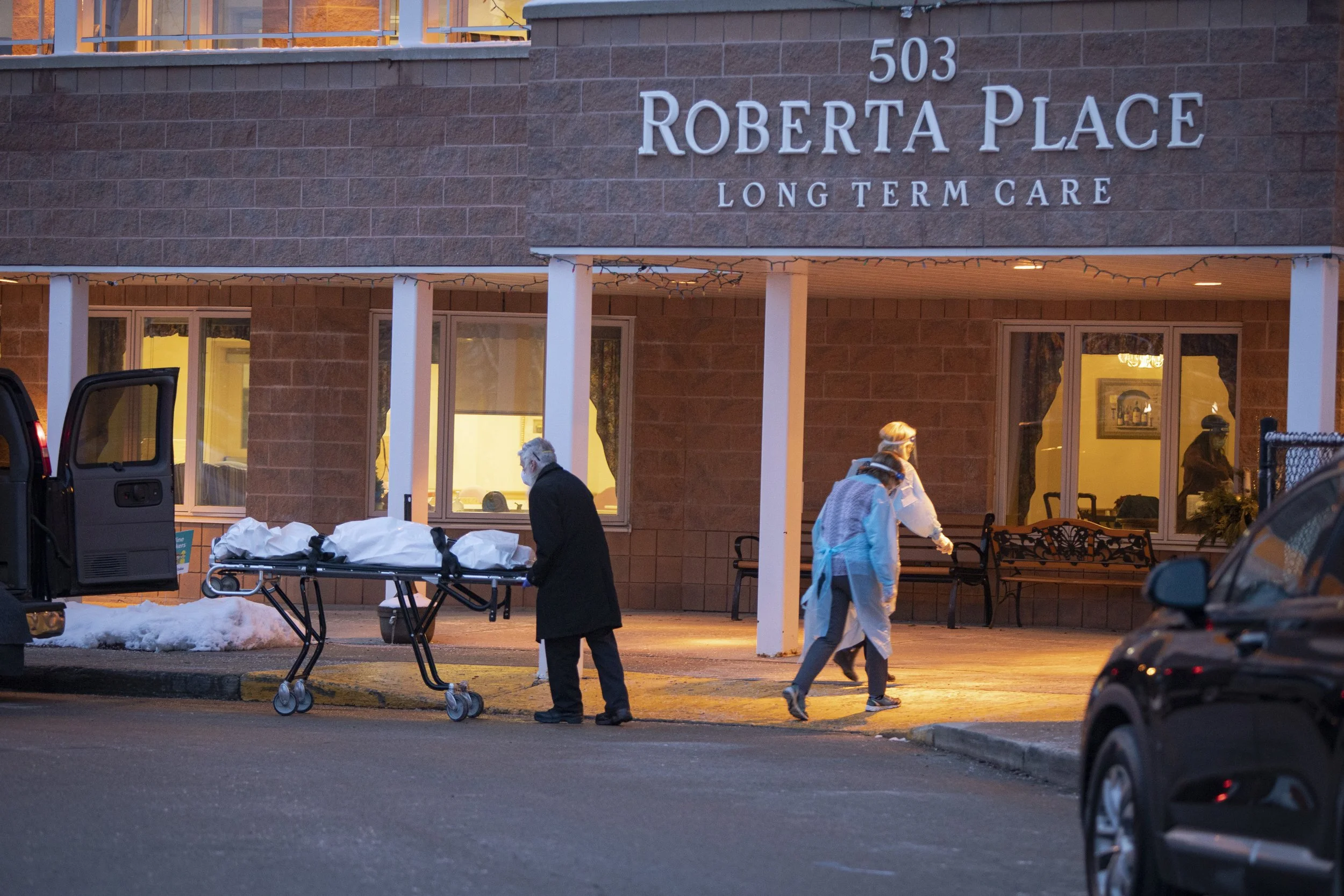 The body of a deceased resident of Roberta Place long term care home, in Barrie, Ont., is removed on Jan. 18, 2021.