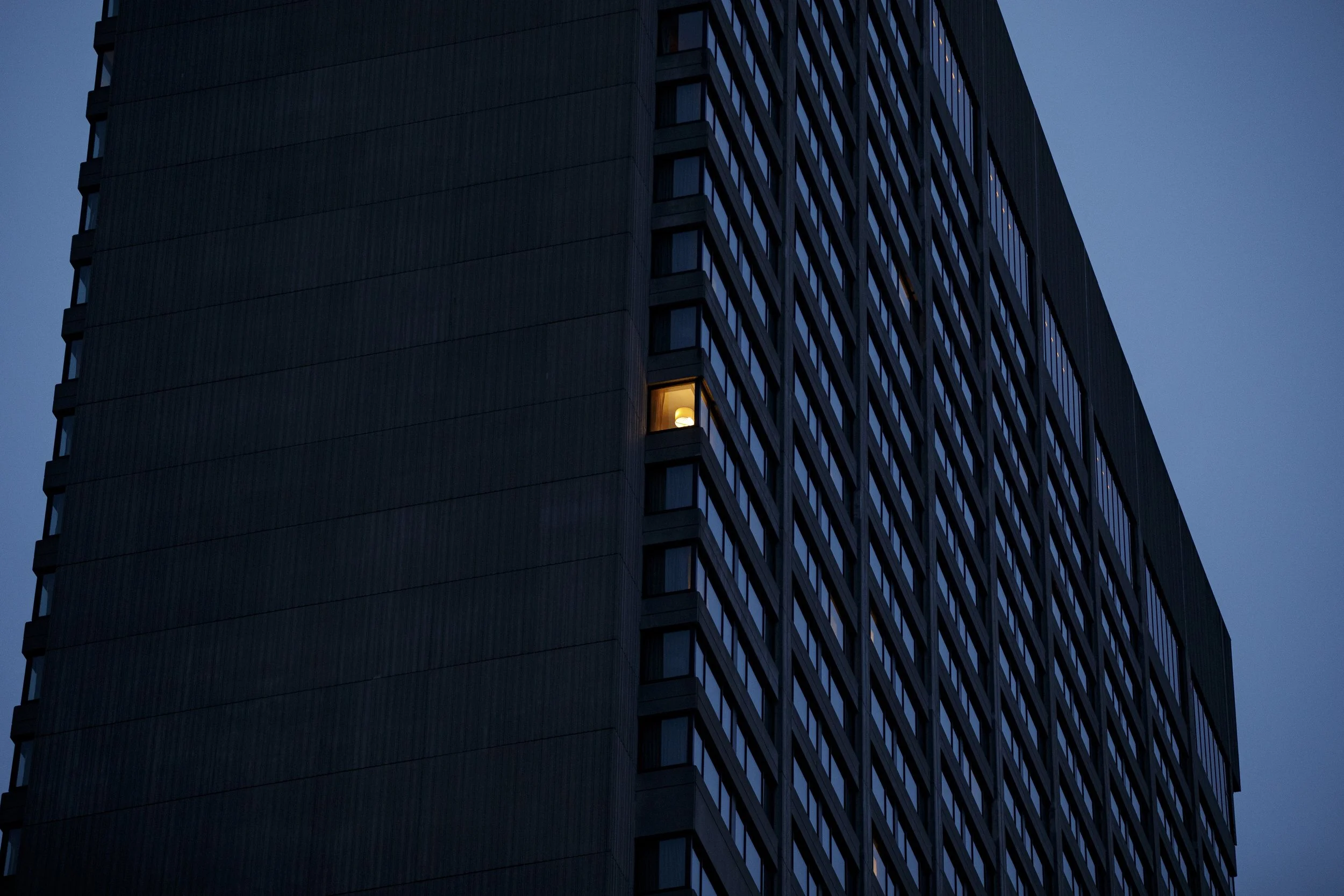 A single light illuminates a room in downtown Toronto quarantine hotel on Jan. 4, 2022.
