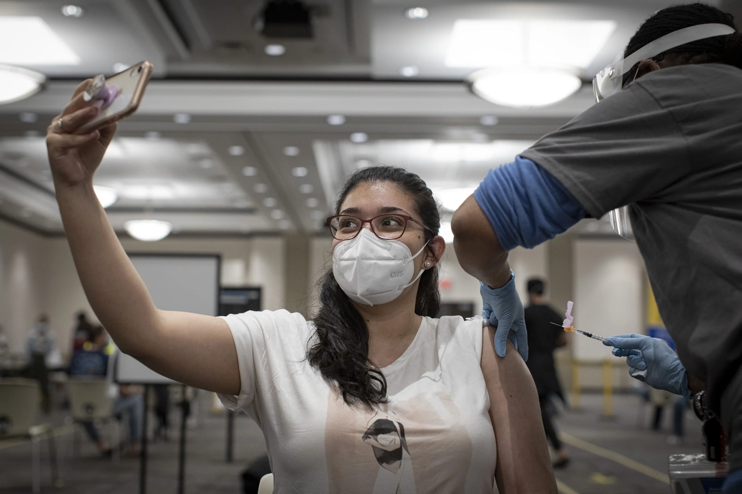 Maria Rey, 27, gets her first does at an overnight clinic in Mississauga, Ont., on May 16 and 17, 2021.