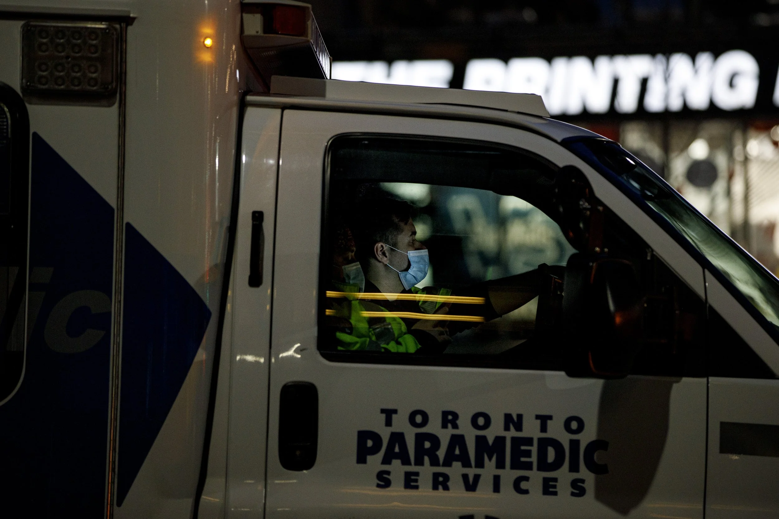 Ambulance paramedics wait to unload a patient in downtown Toronto on Jan. 4, 2022. 