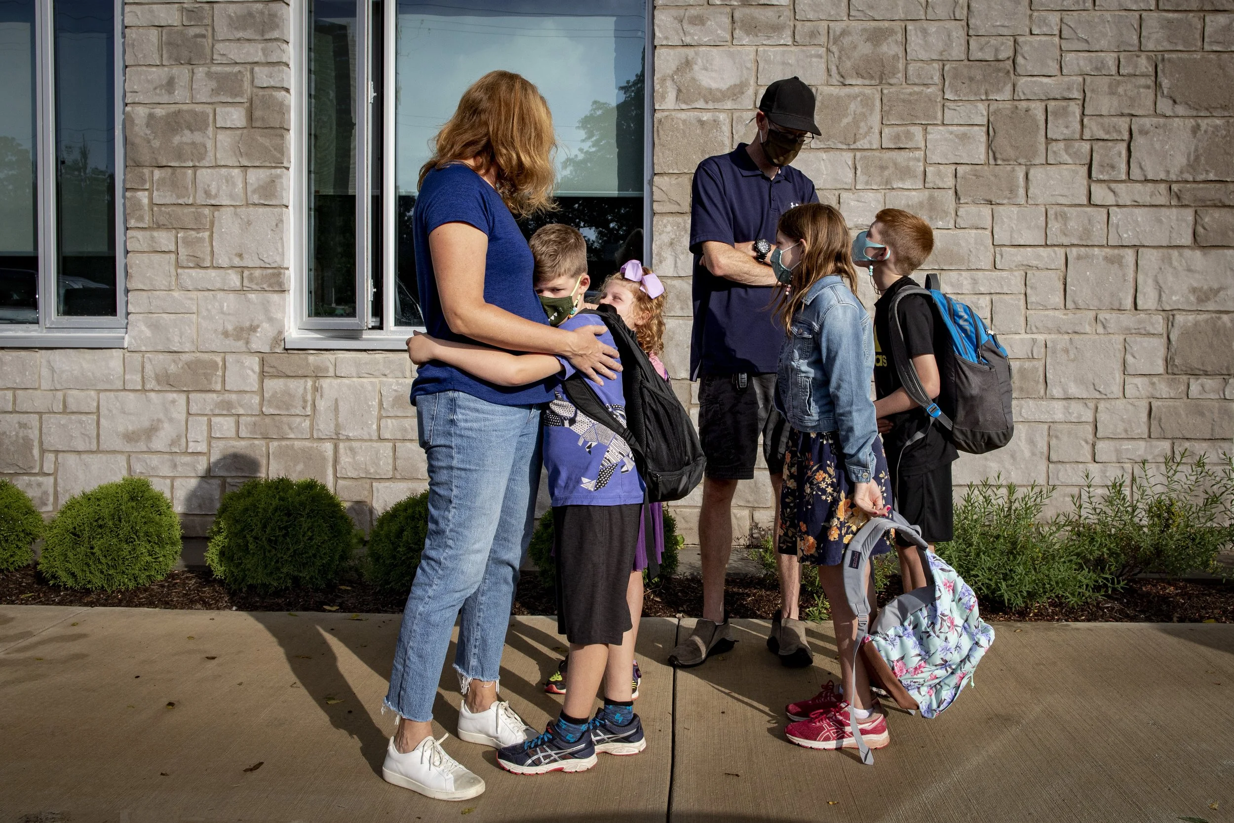 Finn Misener, 6, hugs his mother Jenn before lining up for his first day of grade one at Spring Valley Elementary School, in Ancaster, Ont., on Sept. 8, 2021.