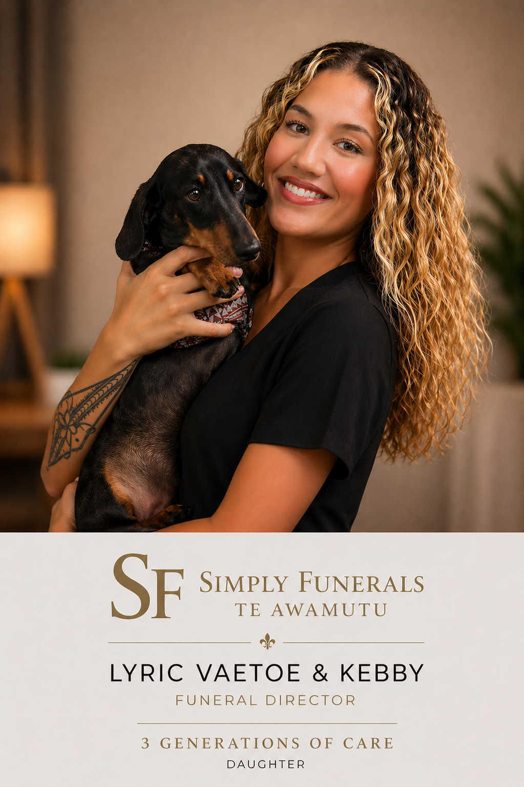 A woman with curly blonde hair holding a black and tan dachshund dog against a background of green tropical plants.