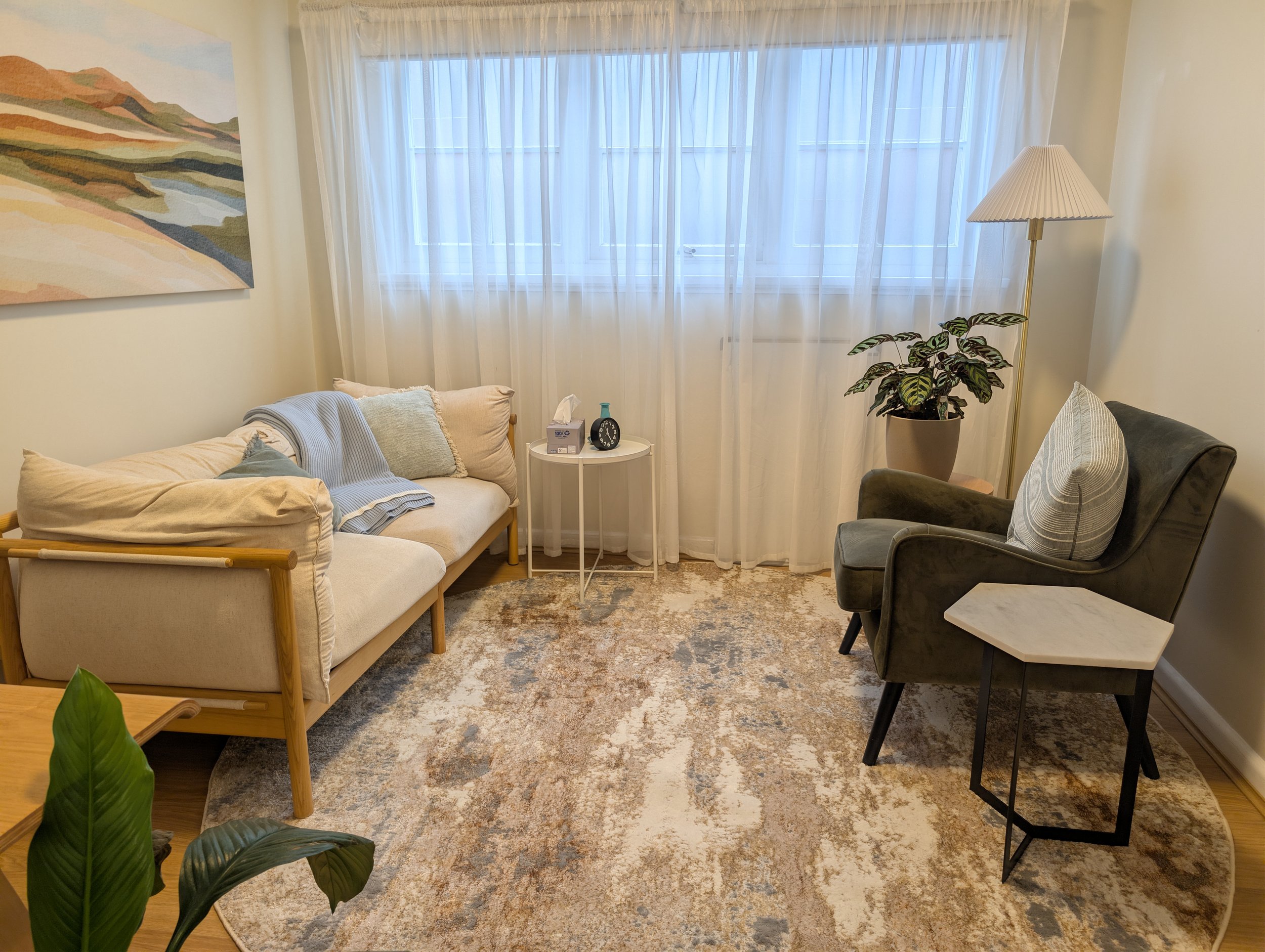 A warmly lit, neuro-affirming therapy consulting room at Ground & Grow Psychology in Moonee Ponds.