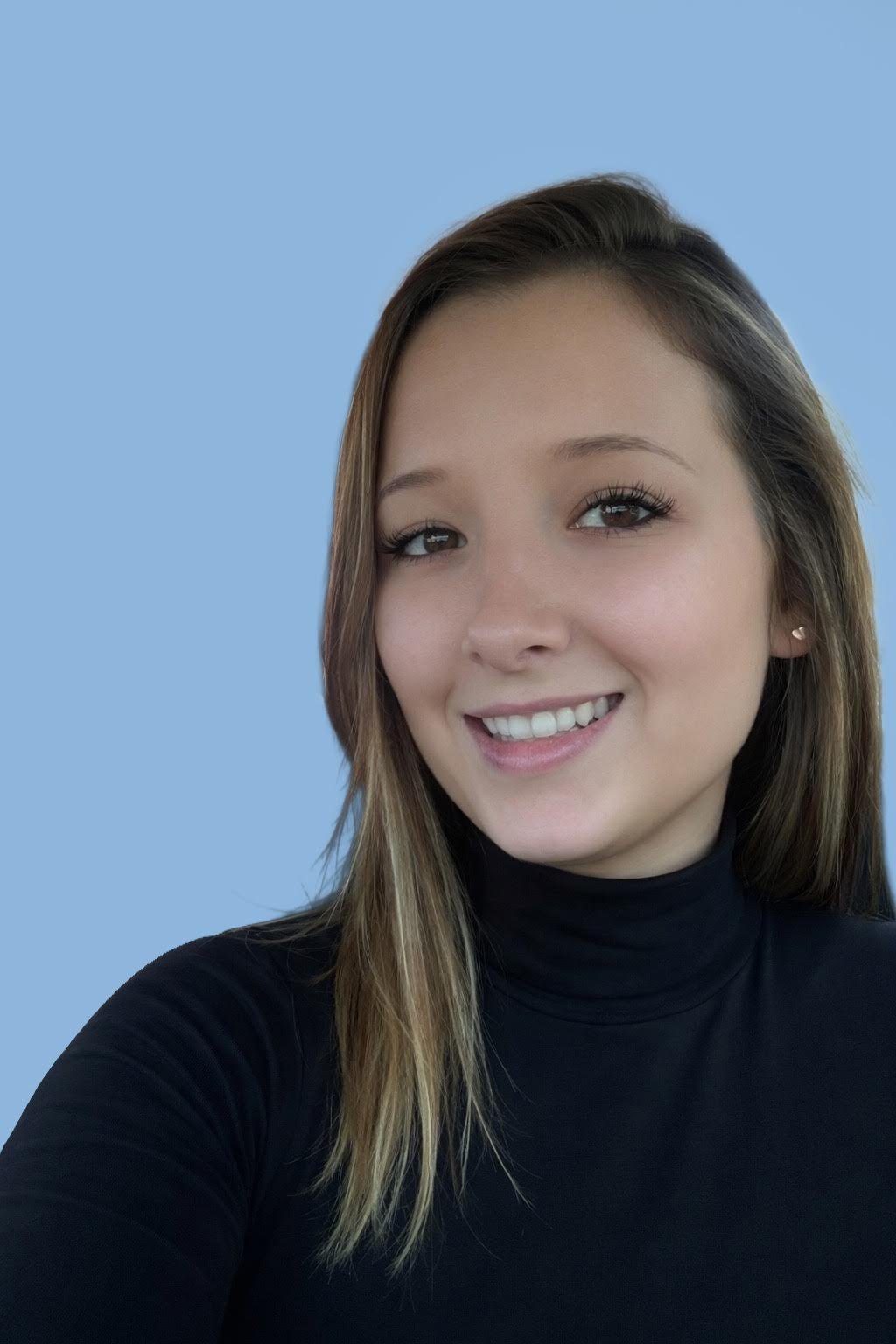 A young woman with light brown hair, wearing a black turtleneck, smiling against a blue background.