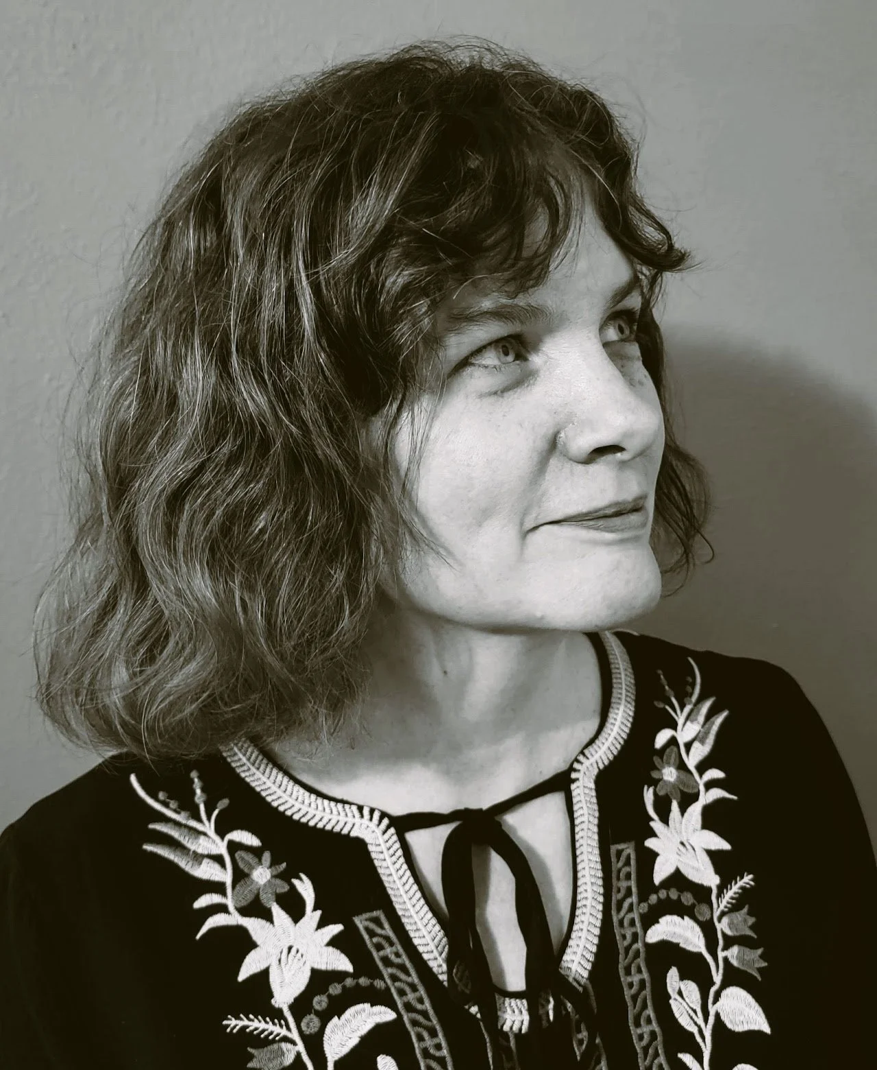 Female occupational therapist for trauma in Vancouver BC wearing a floral shirt smiling.