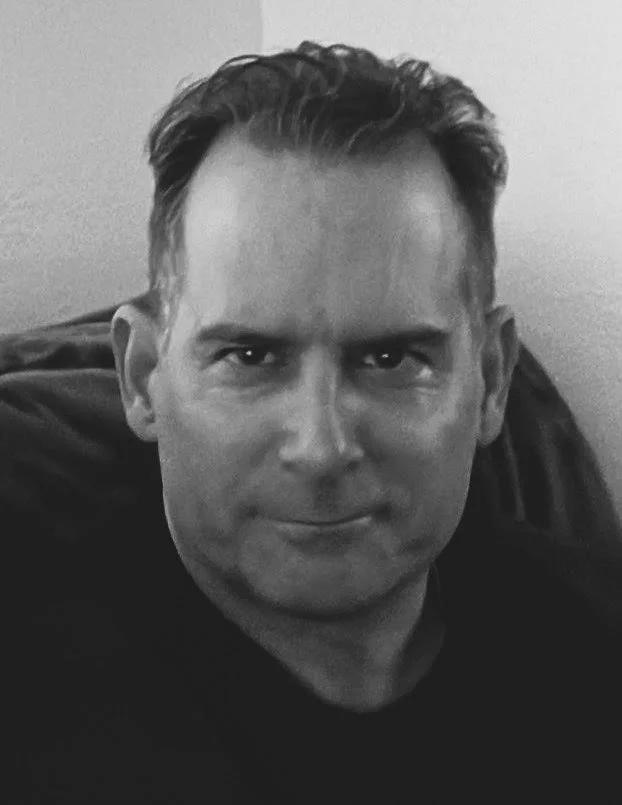 A headshot of a male admin for occupational therapy for trauma in BC in black and white