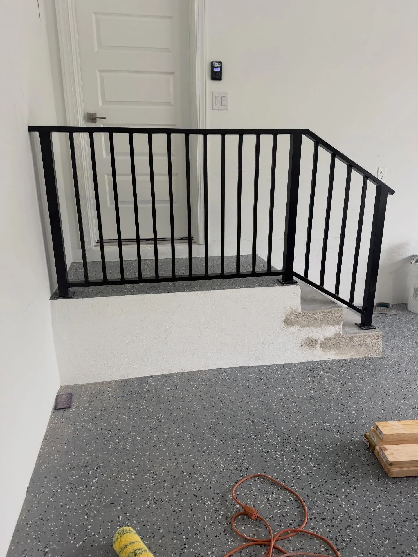 Clean and simple garage railing. Aluminum with vertical pickets finished in black powder coat. #customfab #fabrication #fabricator #aluminumwelding #handrail