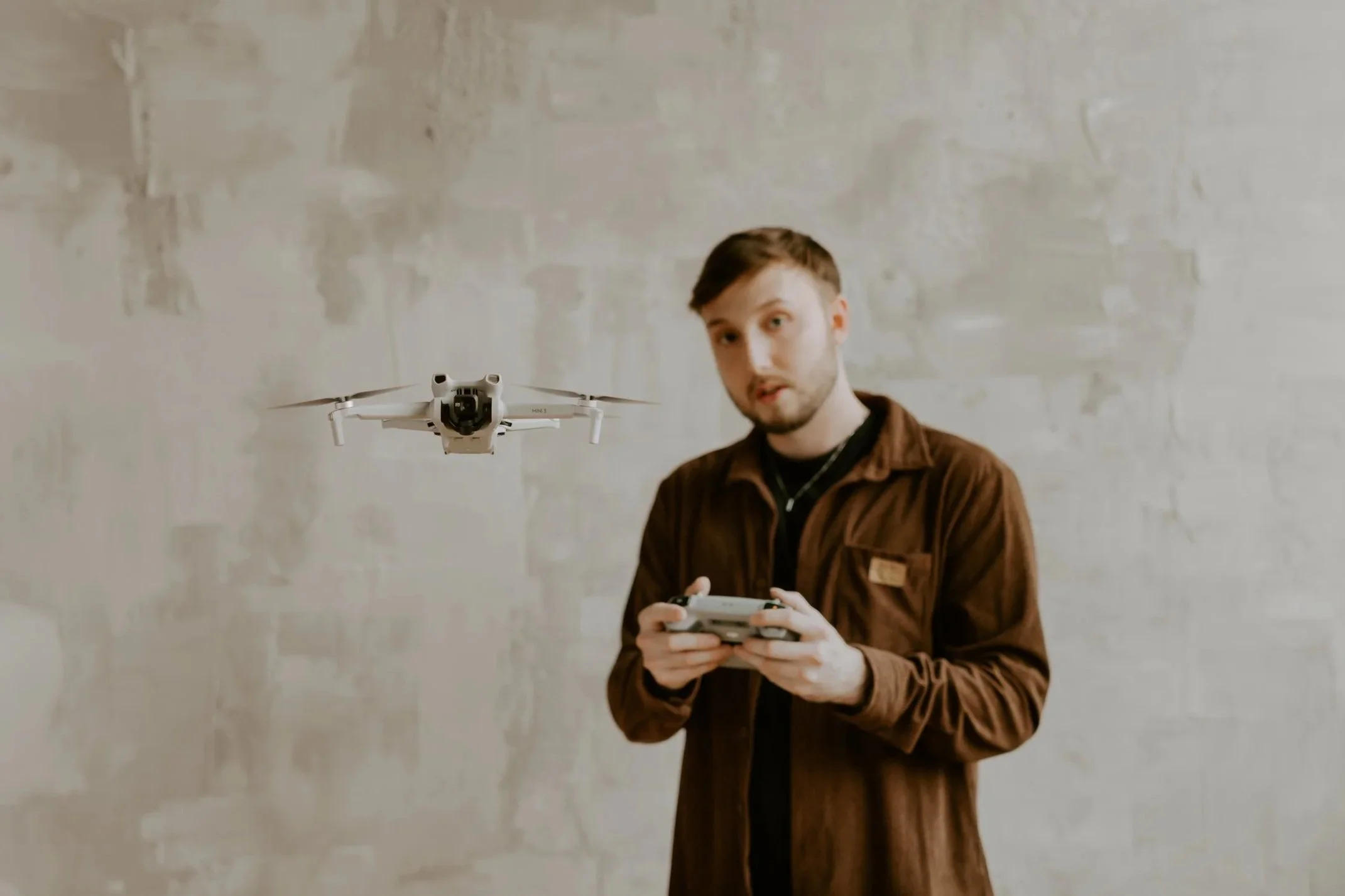 William Randall operating a drone with a remote controller during a content shoot.