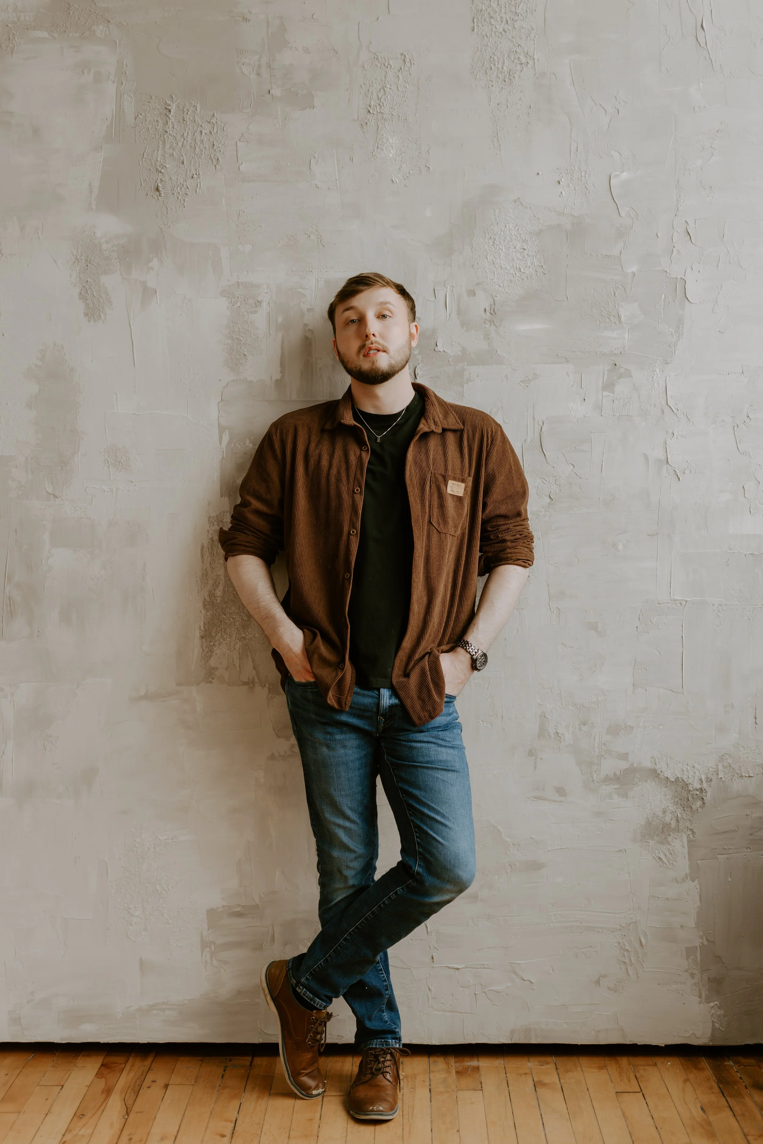 William Randall standing casually in a studio setting during a photoshoot.