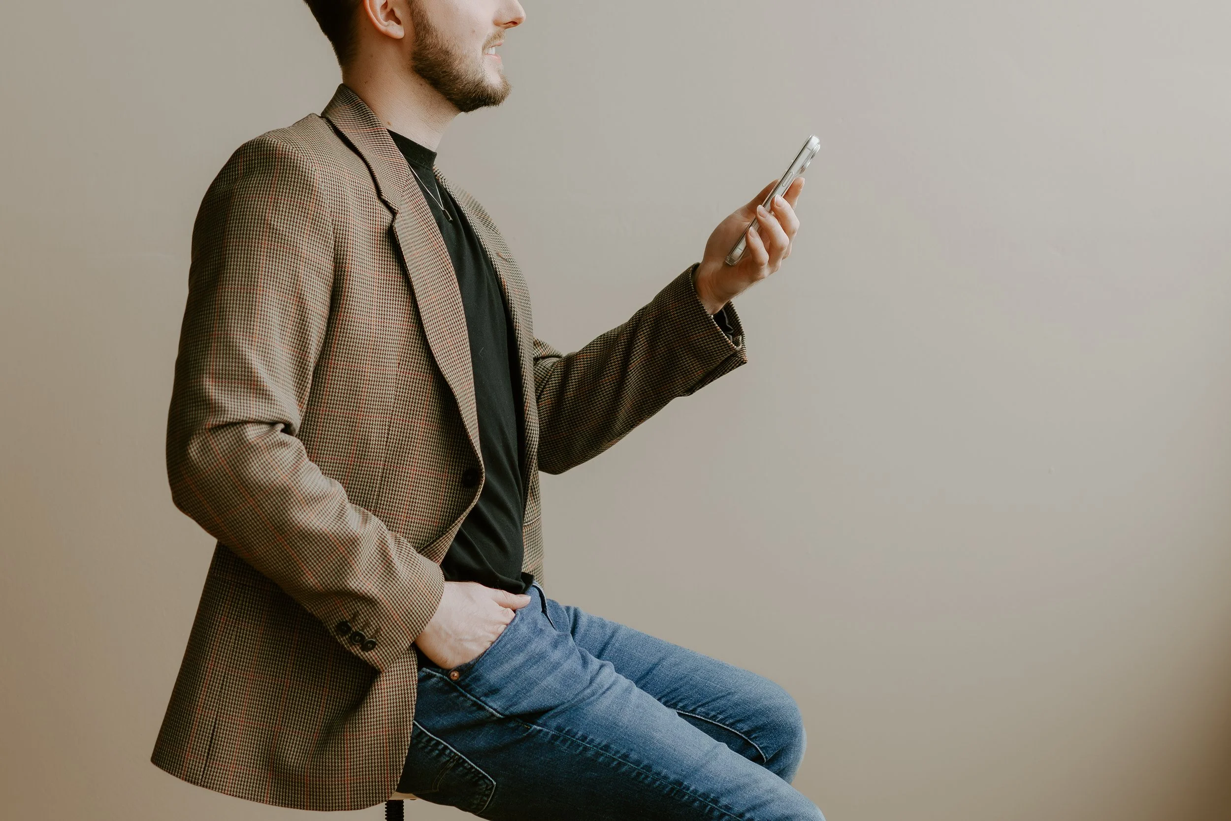 William Randall using a smartphone to film social media content.