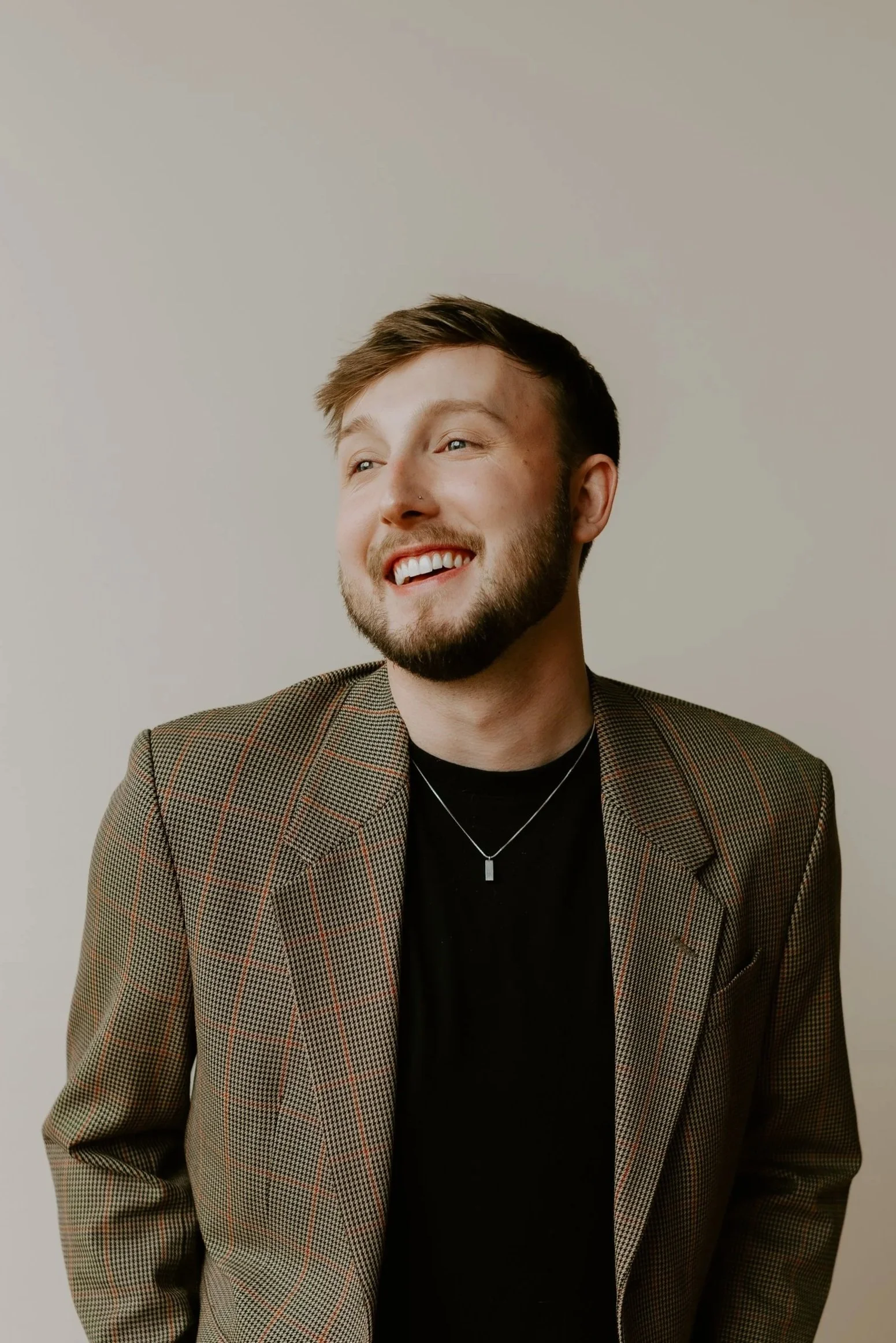 William Randall smiling in a studio portrait wearing a blazer.