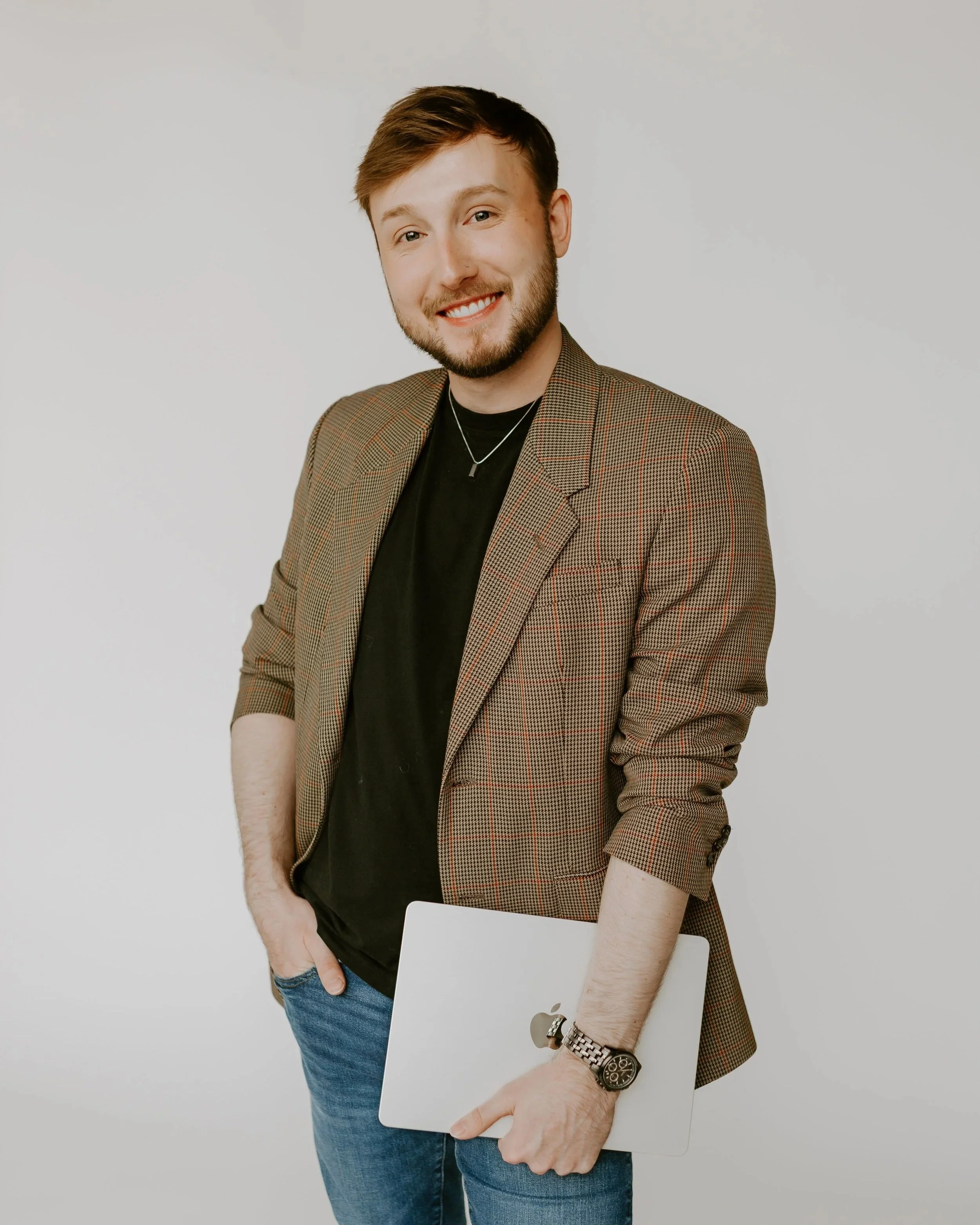 William Randall smiling in a professional studio portrait wearing a blazer.