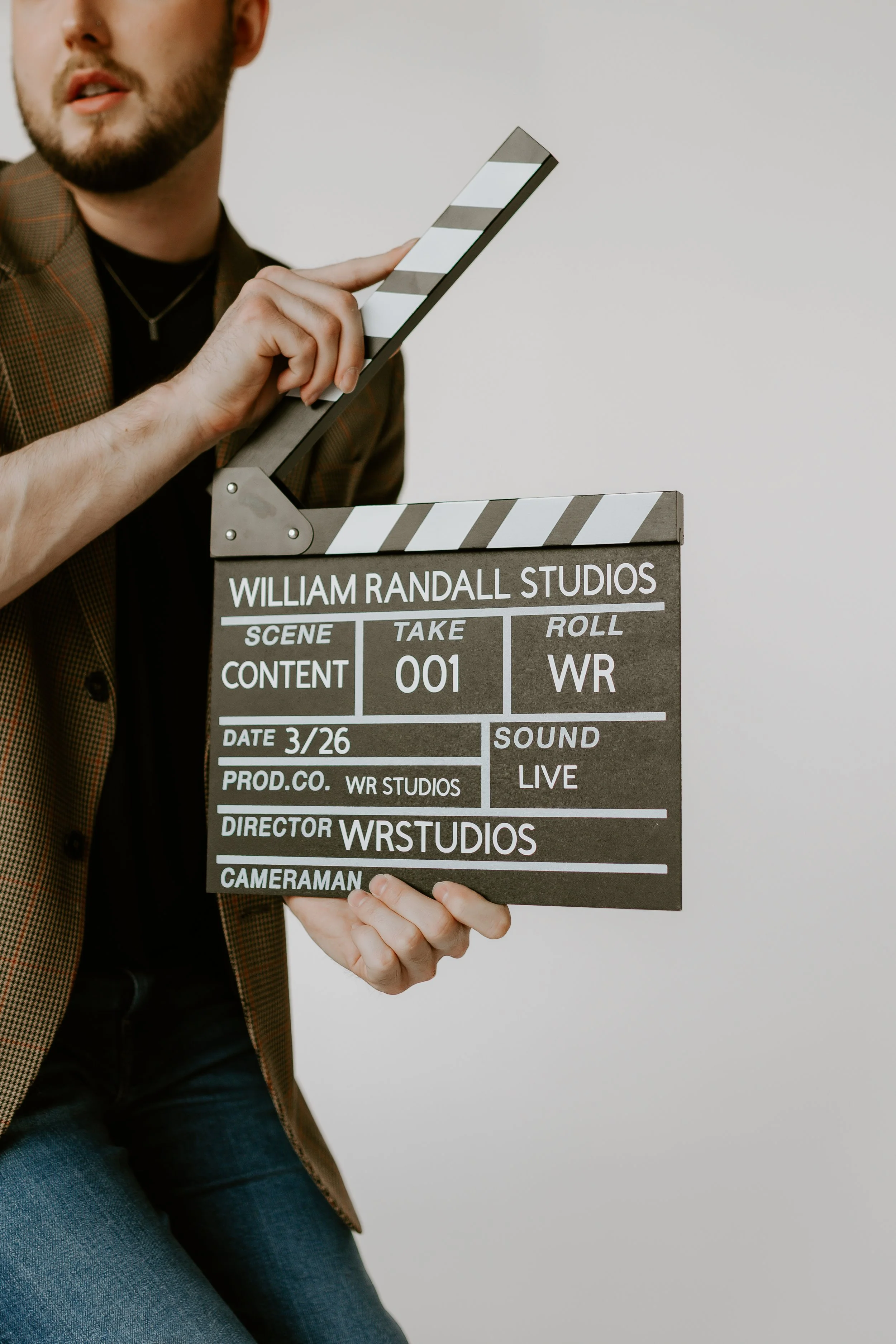 William Randall holding a clapperboard during a content shoot.