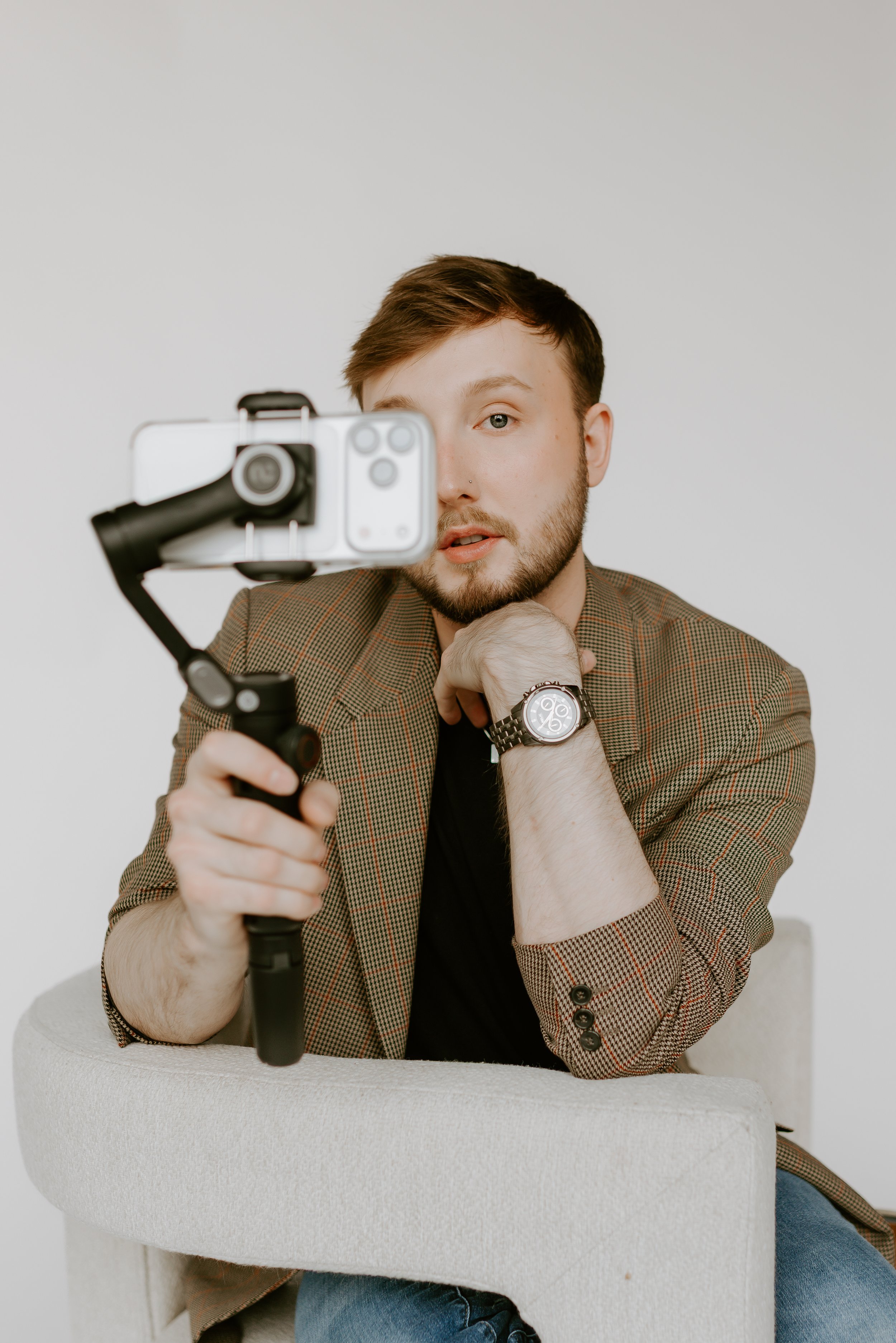 William Randall holding a camera setup while creating video content.