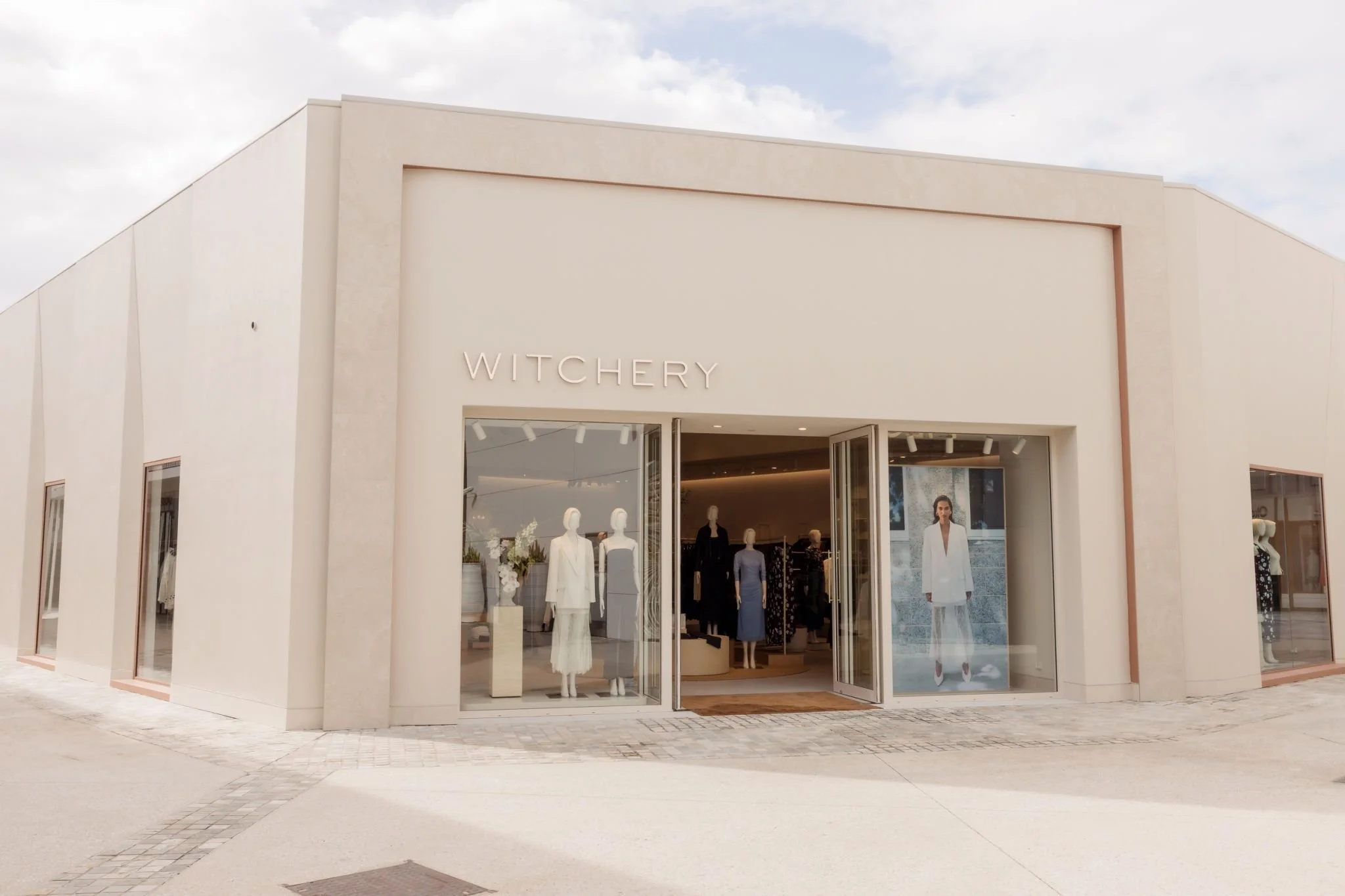 Exterior of a clothing store named Witchery with mannequins in the window displaying fashion outfits.