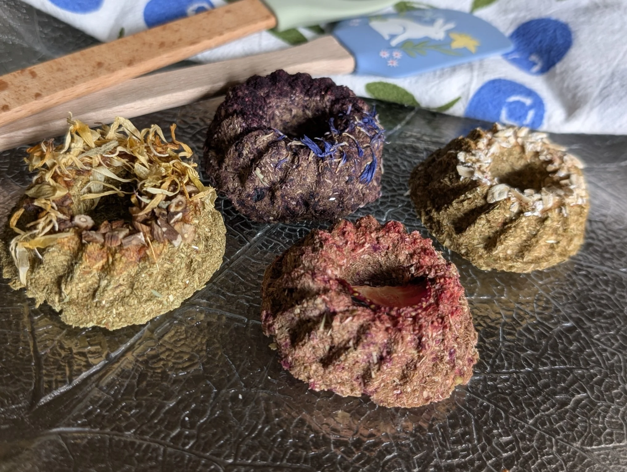 Various herbal incense cones arranged on a glass dish with a textured surface.