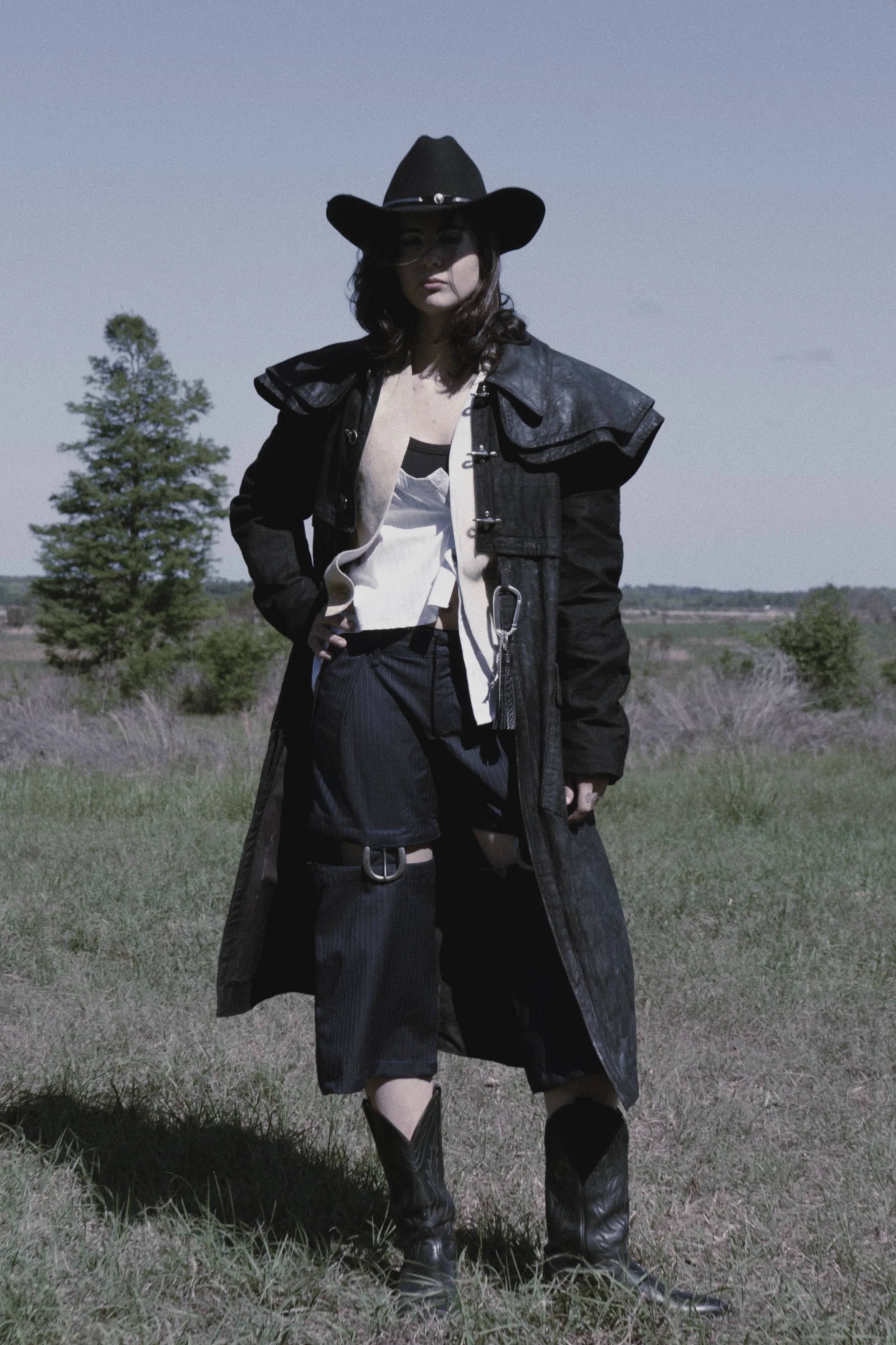 Bib-buttoned shirt styled open with carabiner.