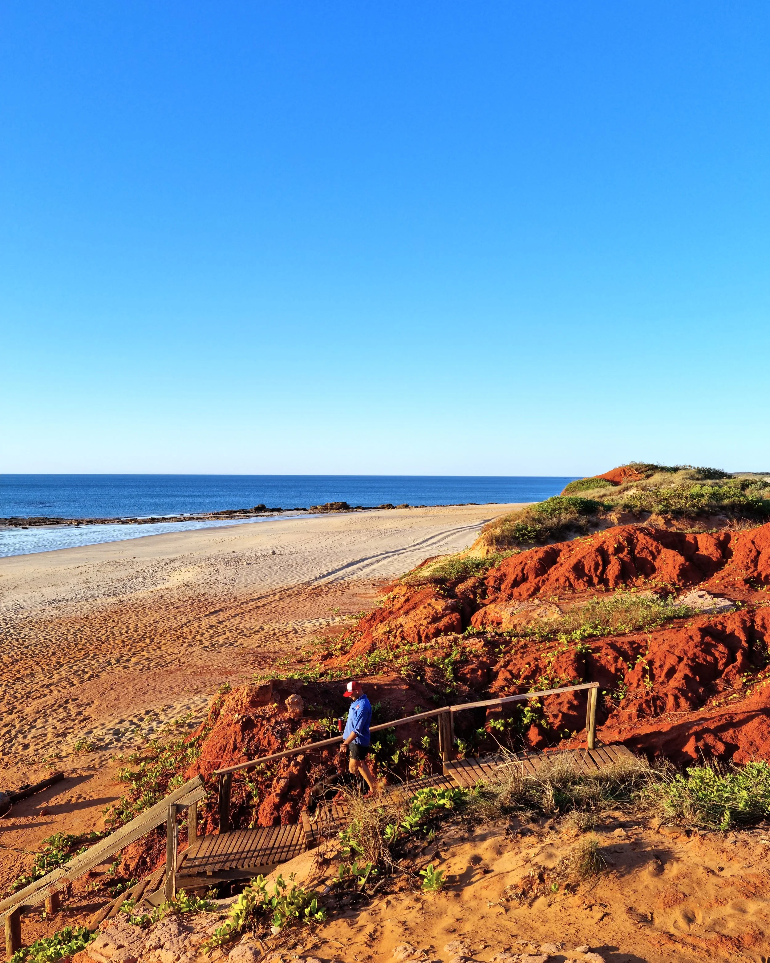 Jessie from Cooee Constructions on the red pindan cliffs at Cable Beach, Broome Western Australia
