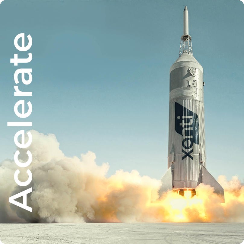 A rocket with the Xplore logo launching with flames and smoke at the base, set against a clear sky