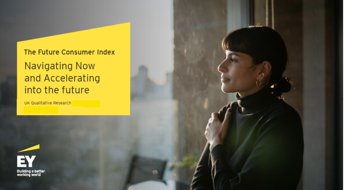 A woman with dark hair and earrings looking out a window with a city skyline in the background, during sunset, with a yellow presentation slide on the left side titled 'The Future Consumer Index' and text about navigating and accelerating into the future, and EY logo at the bottom left.