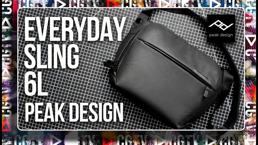 A black sling bag with a front zipper pocket placed on a black grid-patterned surface. The background includes colorful MTV logos and the text 'Everyday Sling 6L Peak Design' written in bold white letters, with a black Peak Design tag attached to the