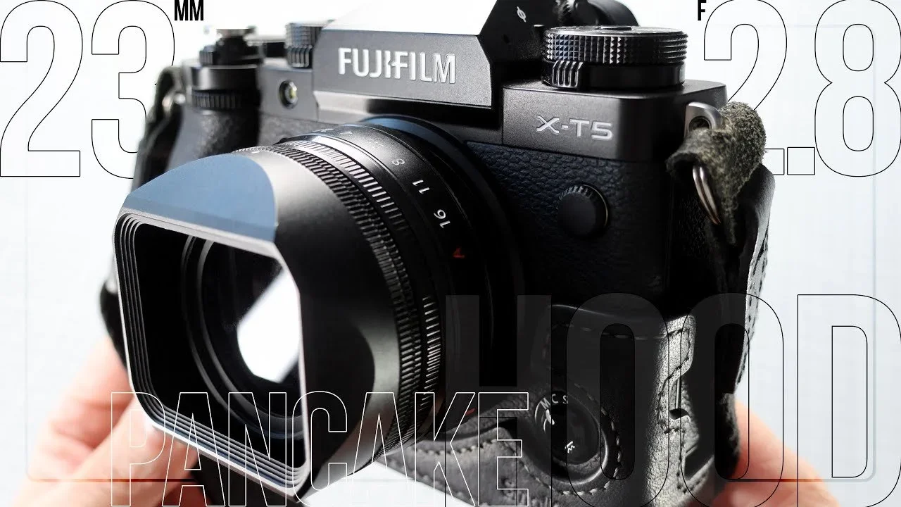 Fujifilm X-T5 mirrorless camera with attached lens and lens hood.