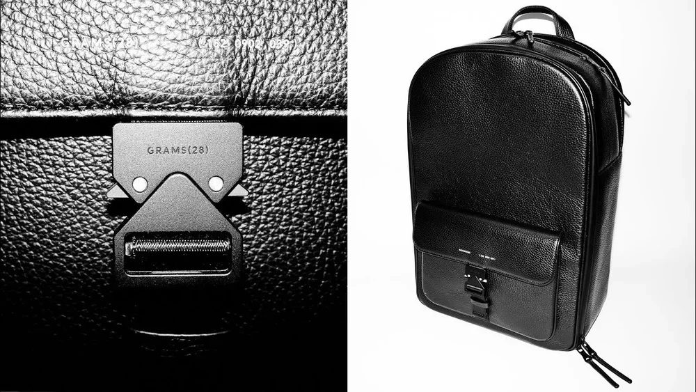 Close-up of a leather bag interior with a metal weight measurement 28 grams, and a black leather backpack with a textured surface and front pocket against a white background.