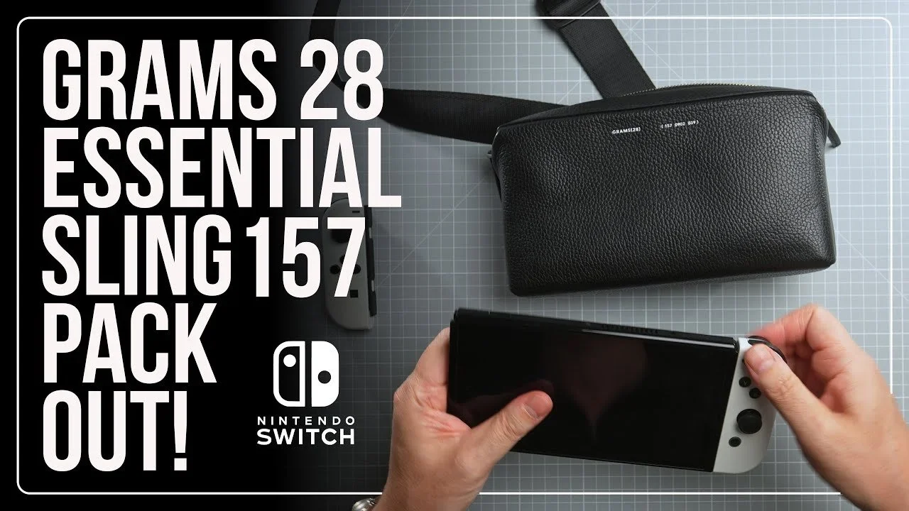Overhead view of a black textured zippered bag, small gray toy gun, and a person's hands holding a Nintendo Switch console on a grey grid background, with large white text reading "28 grams essential sling 15-7 pack out!" and a Nintendo Switch logo.